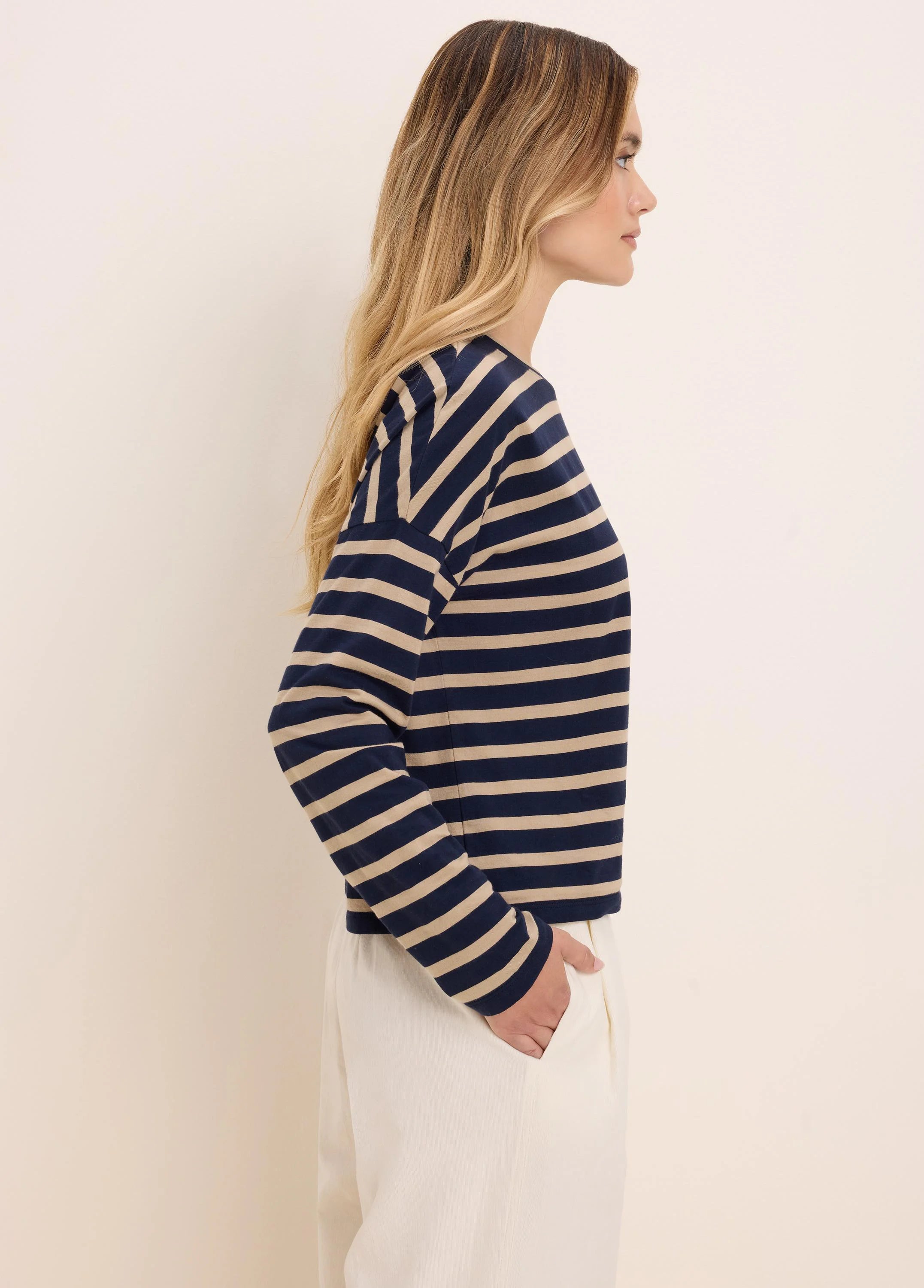 Long-sleeve tee with navy blue and beige horizontal stripes.