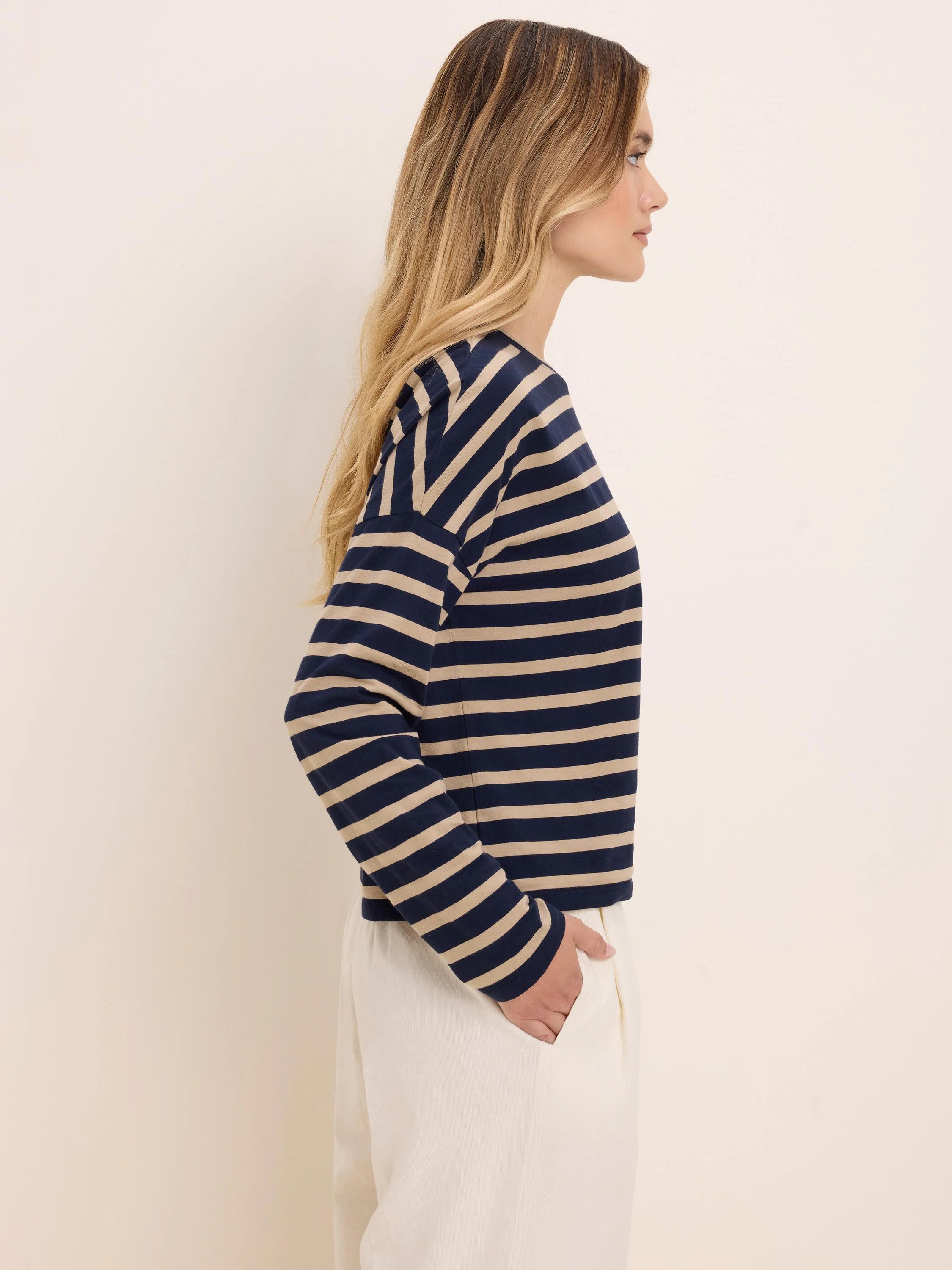 Long-sleeve tee with navy blue and beige horizontal stripes.