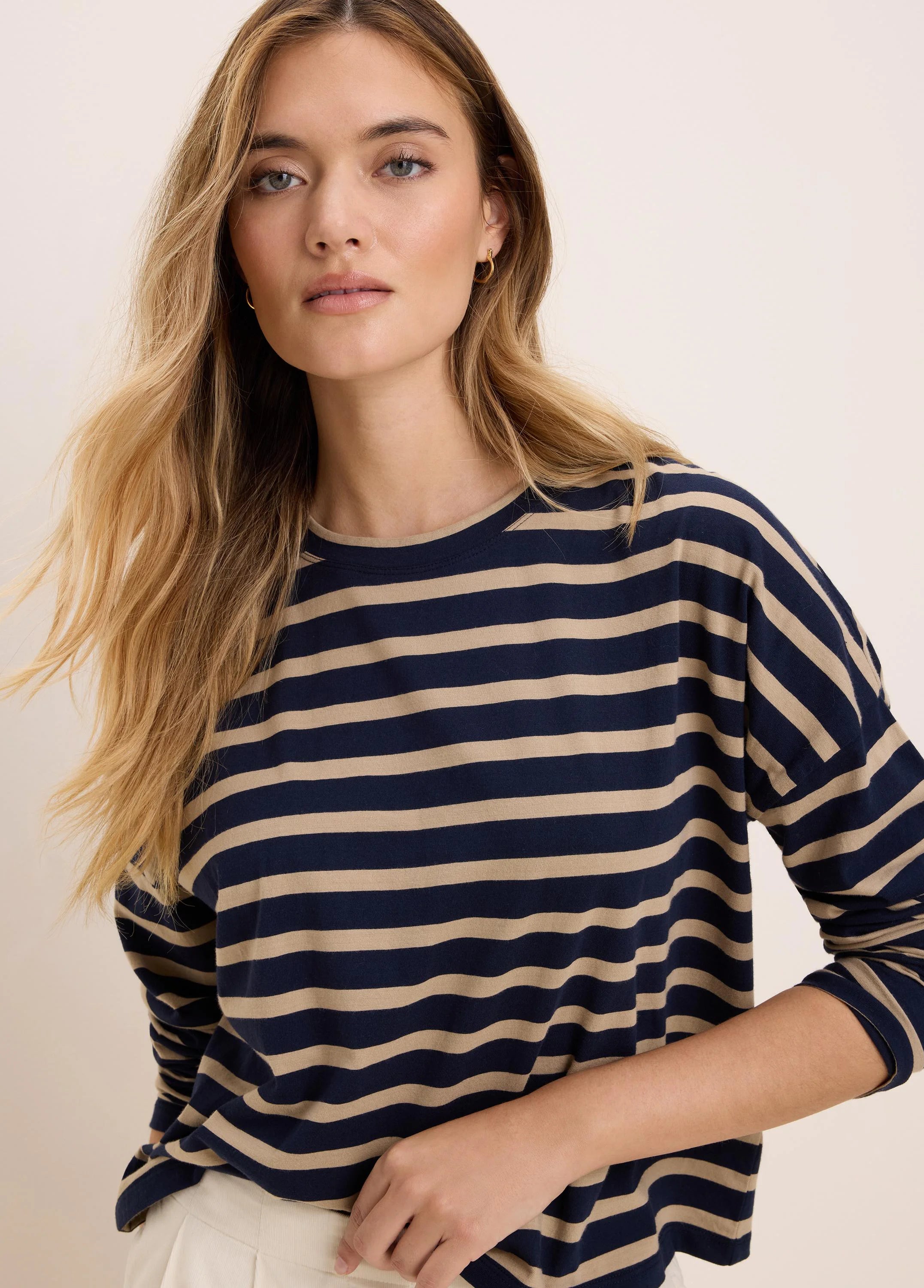 Long-sleeve tee with navy and tan horizontal stripes, crew neck, and relaxed fit.