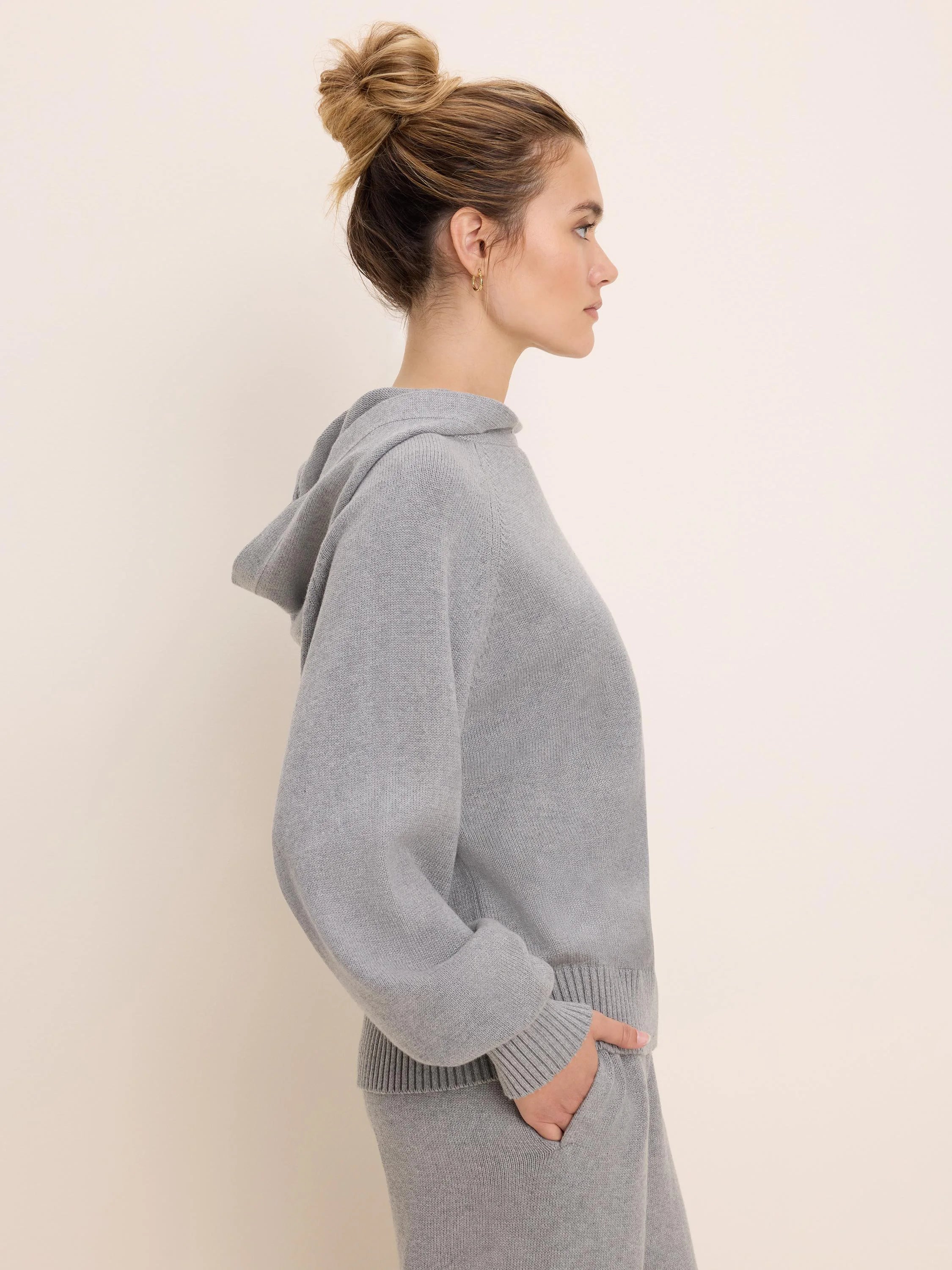 Light grey knit sweater hoodie with a hood, ribbed cuffs and hem.