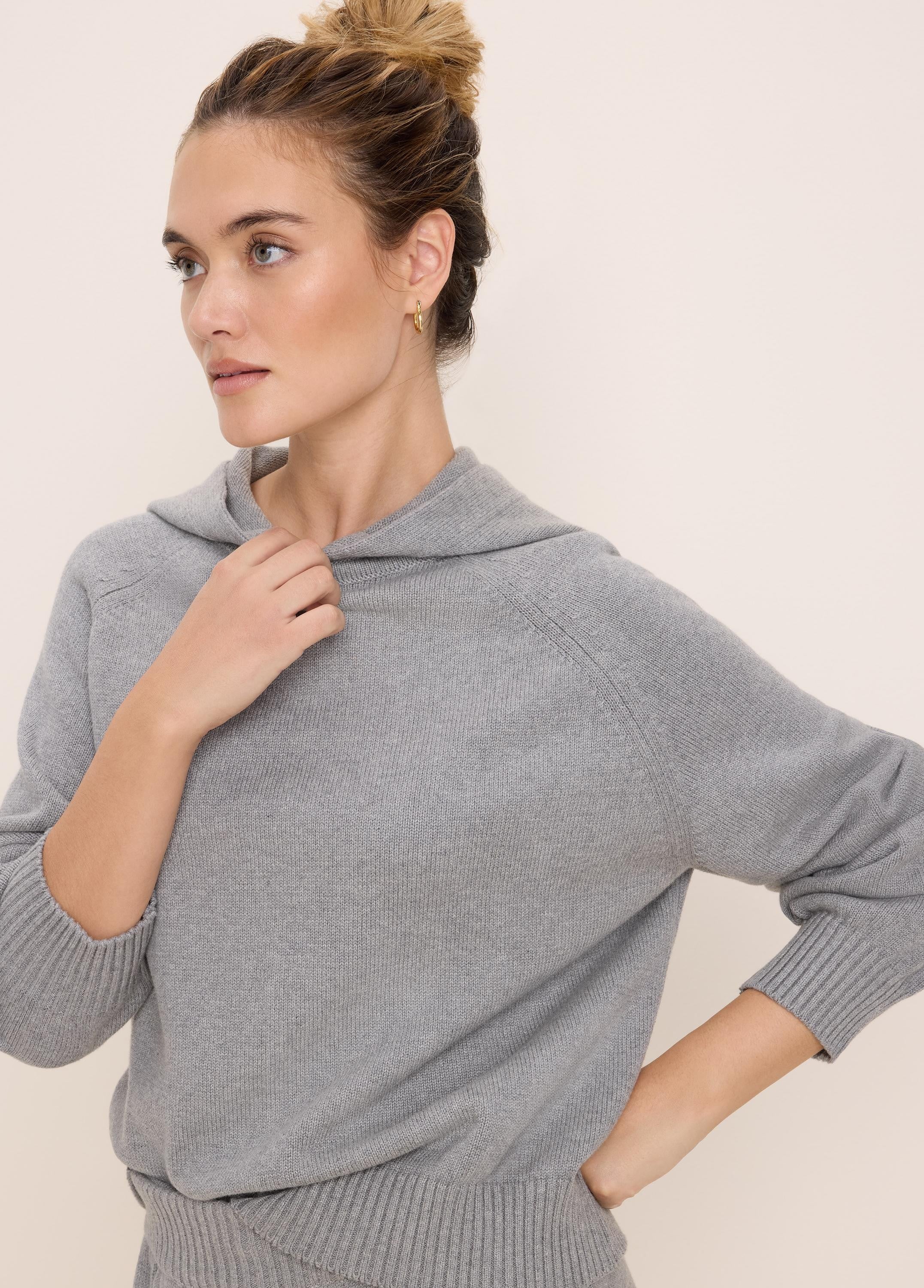Light grey knit sweater hoodie with raglan sleeves, ribbed cuffs and hem.