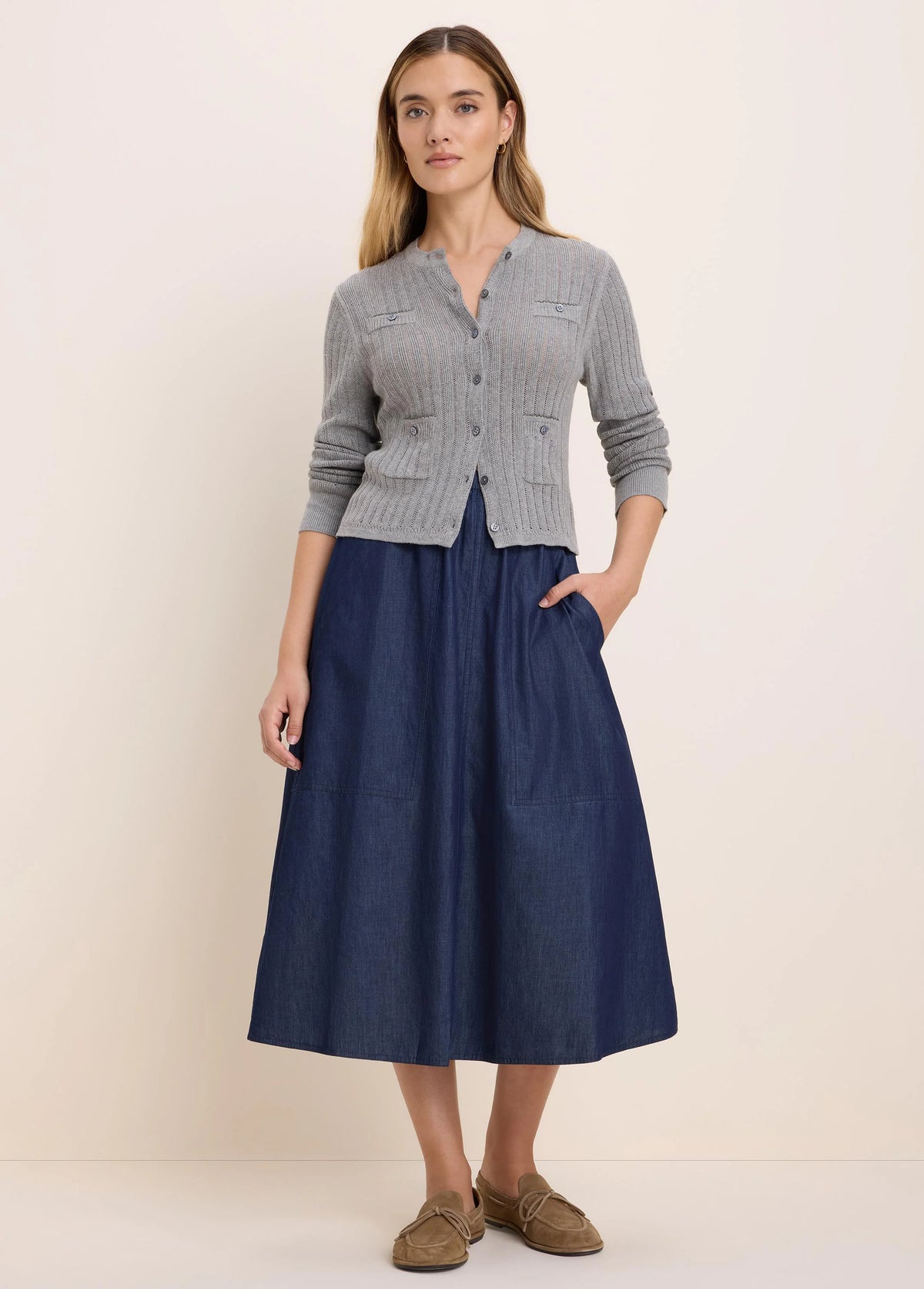 Grey pointelle knit cardigan with a button-up front and two chest patch pockets.
