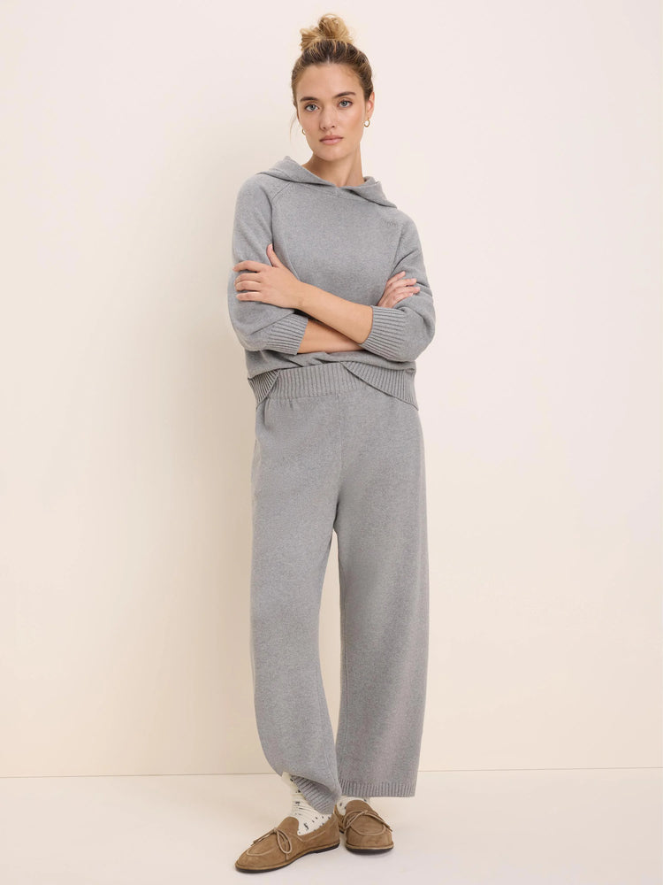 Model wears light grey Billie Sweater Pants, wide-leg, relaxed fit, paired with a matching grey hooded top.
