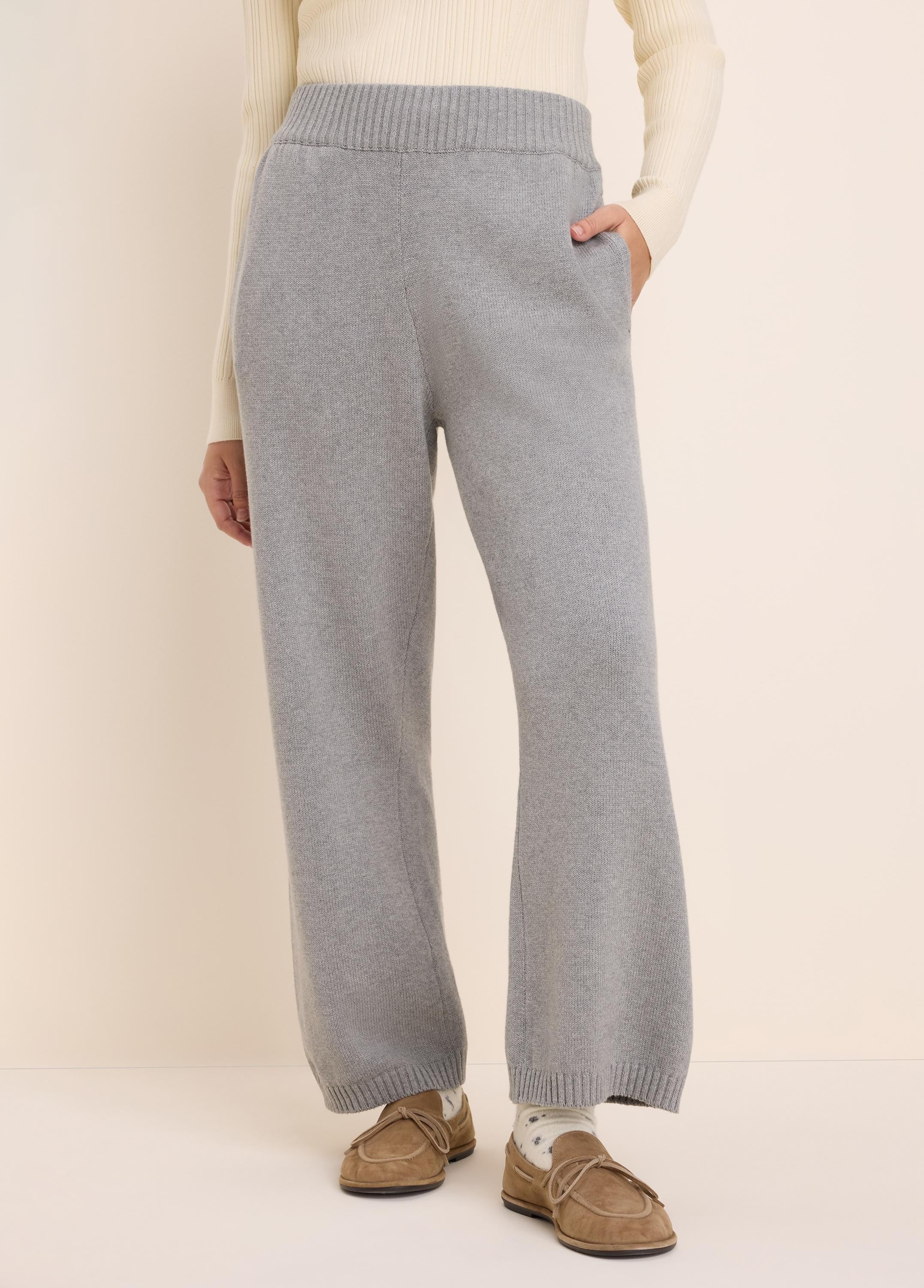Light grey knit sweater pants with a ribbed waist, side pockets, and wide, relaxed legs.