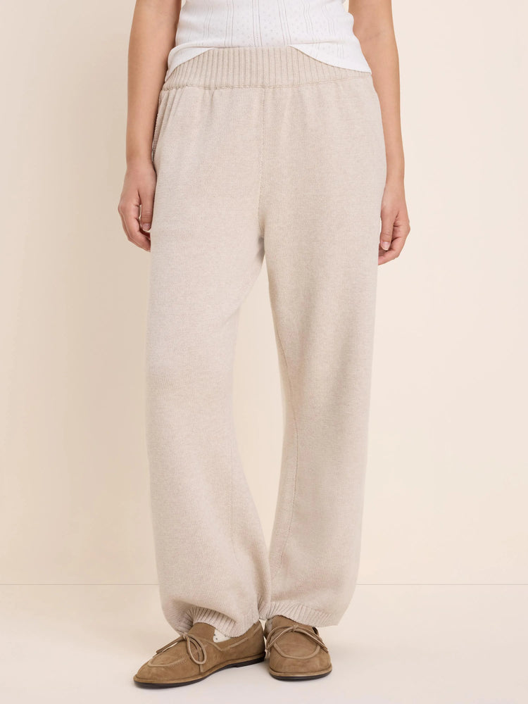 Light beige knit sweater pants with a ribbed waistband and relaxed fit.