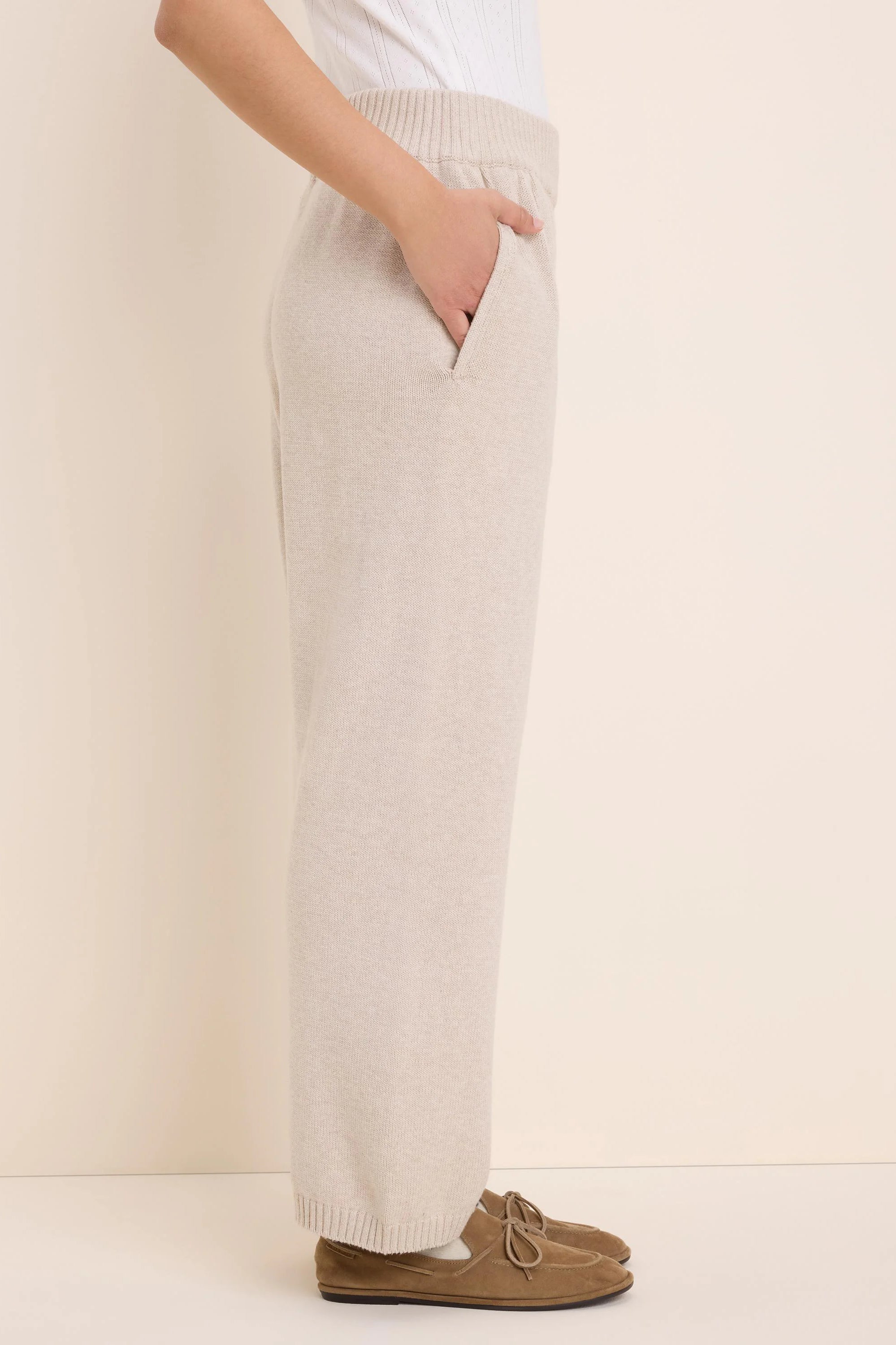 Oatmeal knit wide-leg pants with a ribbed waistband and side pockets.