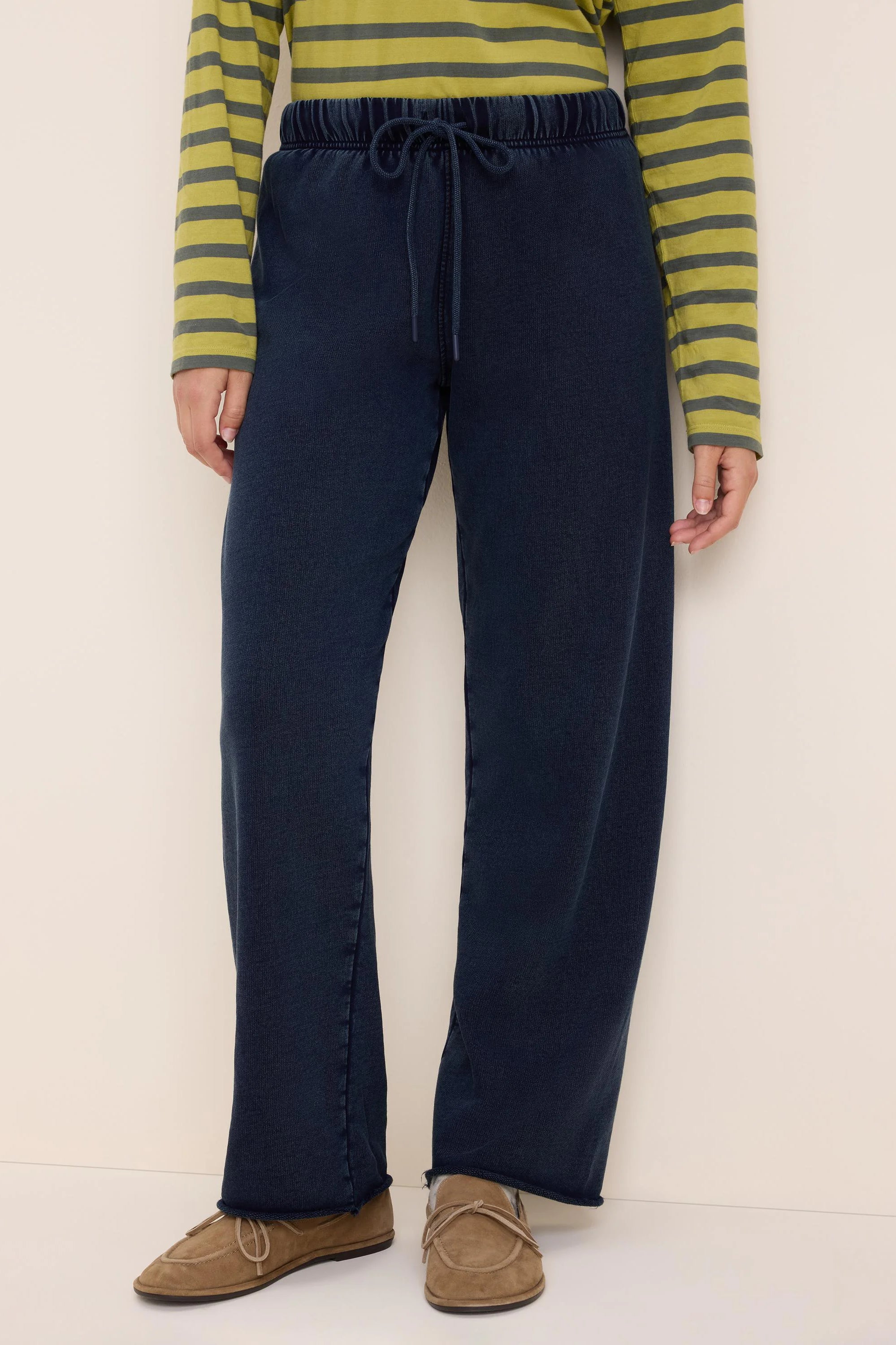 Dark blue wide-leg cotton terry pants with an elastic drawstring waist and raw hem.