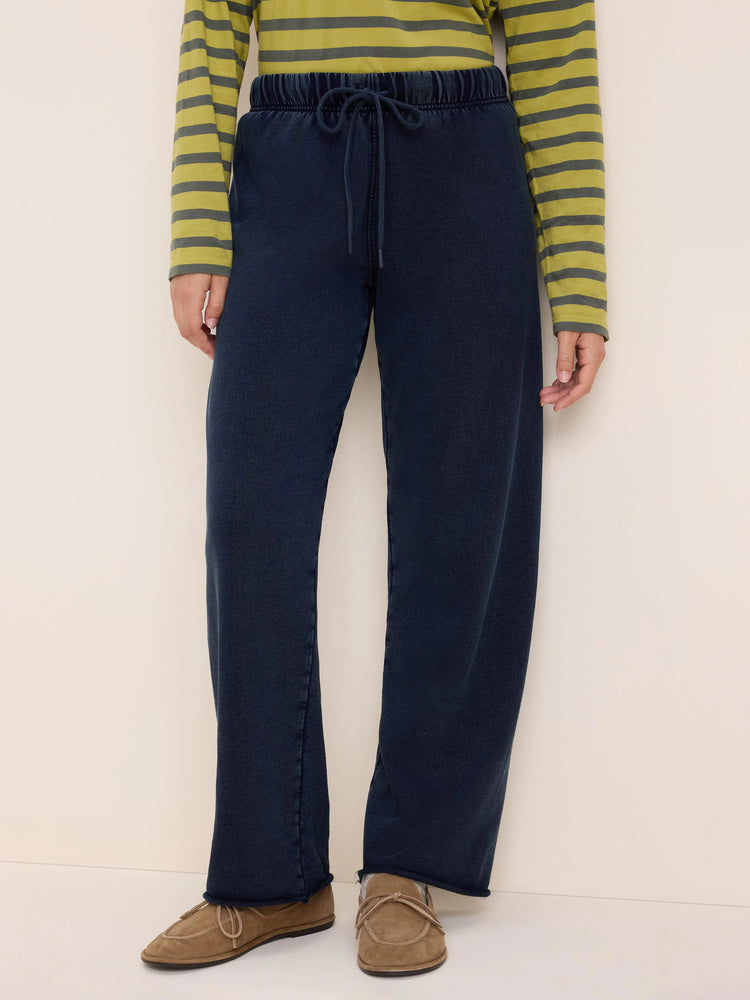 Dark blue wide-leg cotton terry pants with an elastic drawstring waist and raw hem.