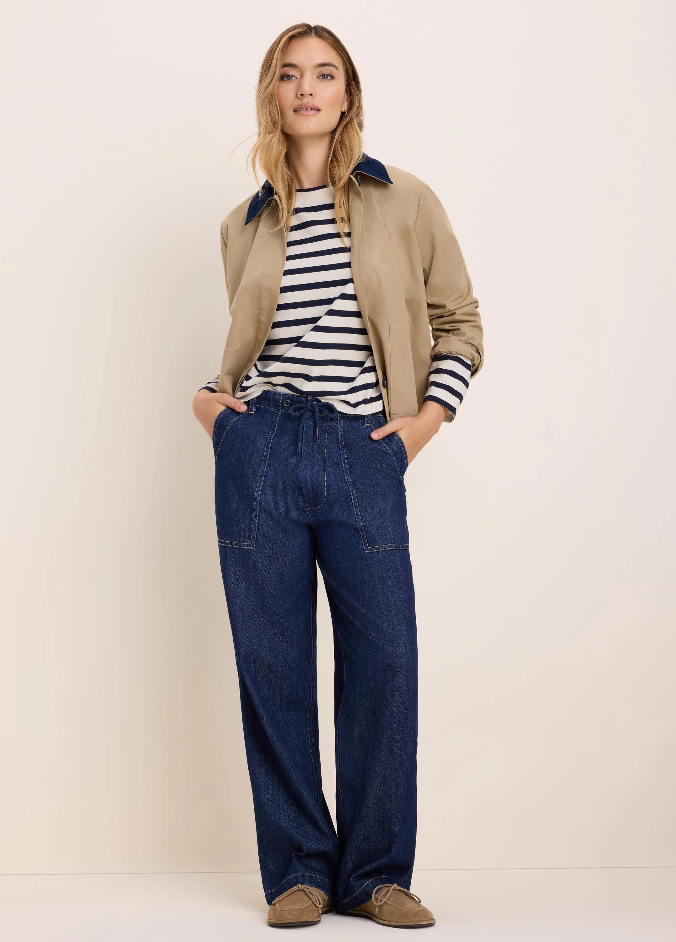 Tan twill jacket with a contrasting navy cord collar. Features include a short length, long sleeves, and front pockets.