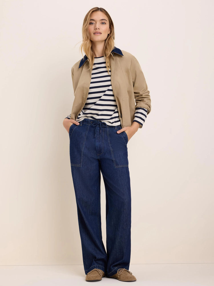 Tan twill jacket with a contrasting navy cord collar. Features include a short length, long sleeves, and front pockets.