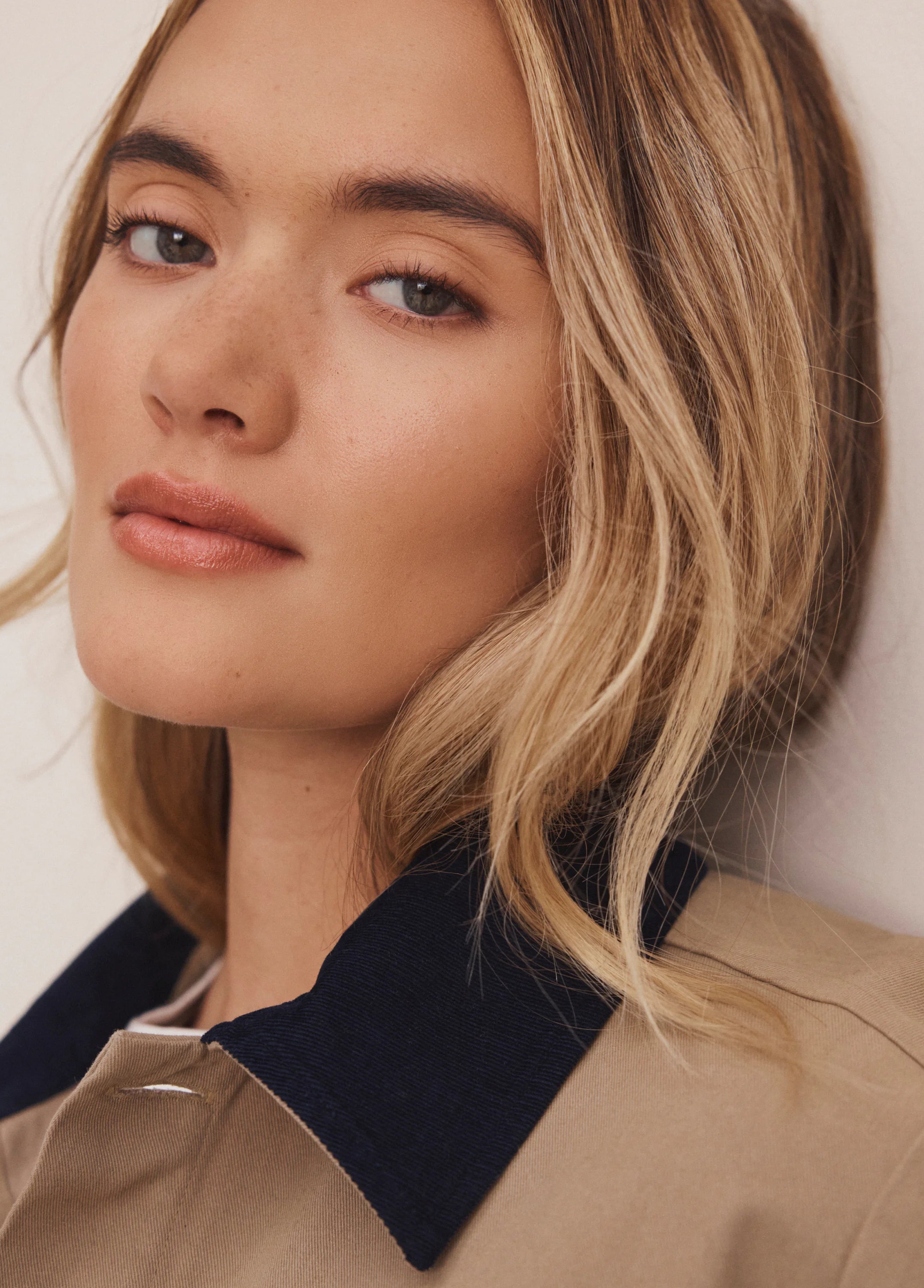 Tan twill jacket with a navy cord collar.