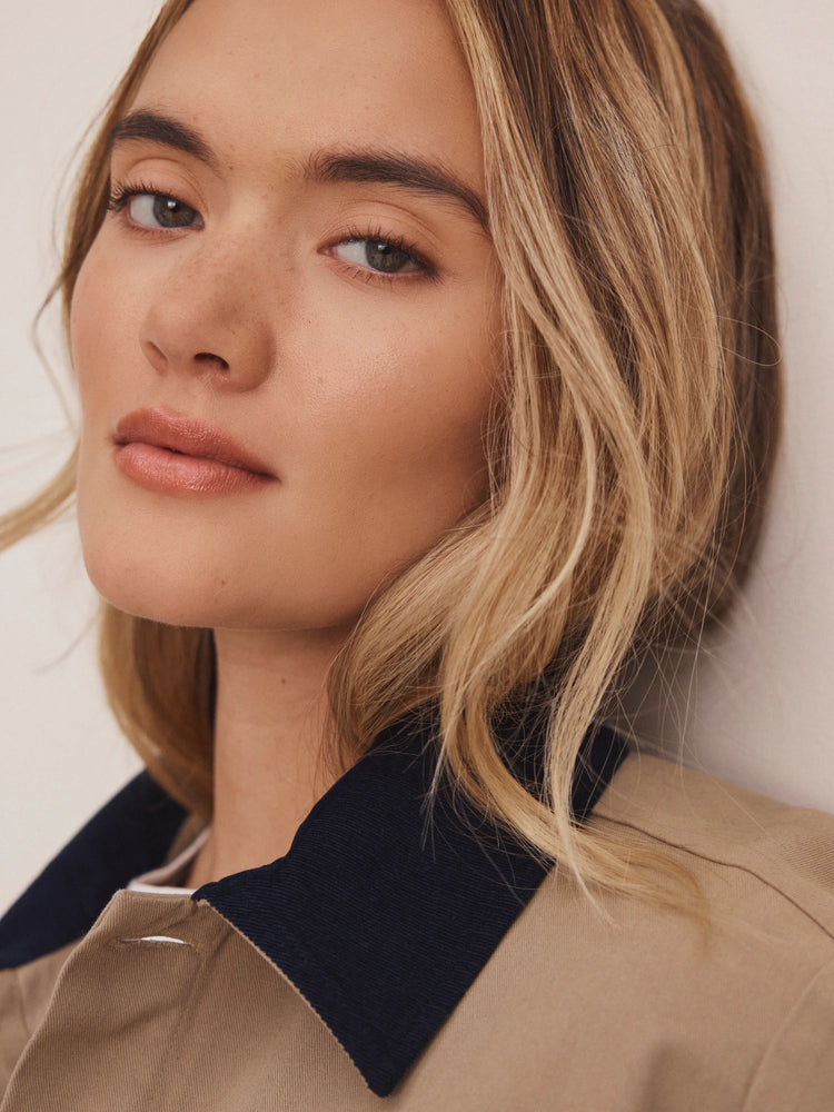 Tan twill jacket with a navy cord collar.