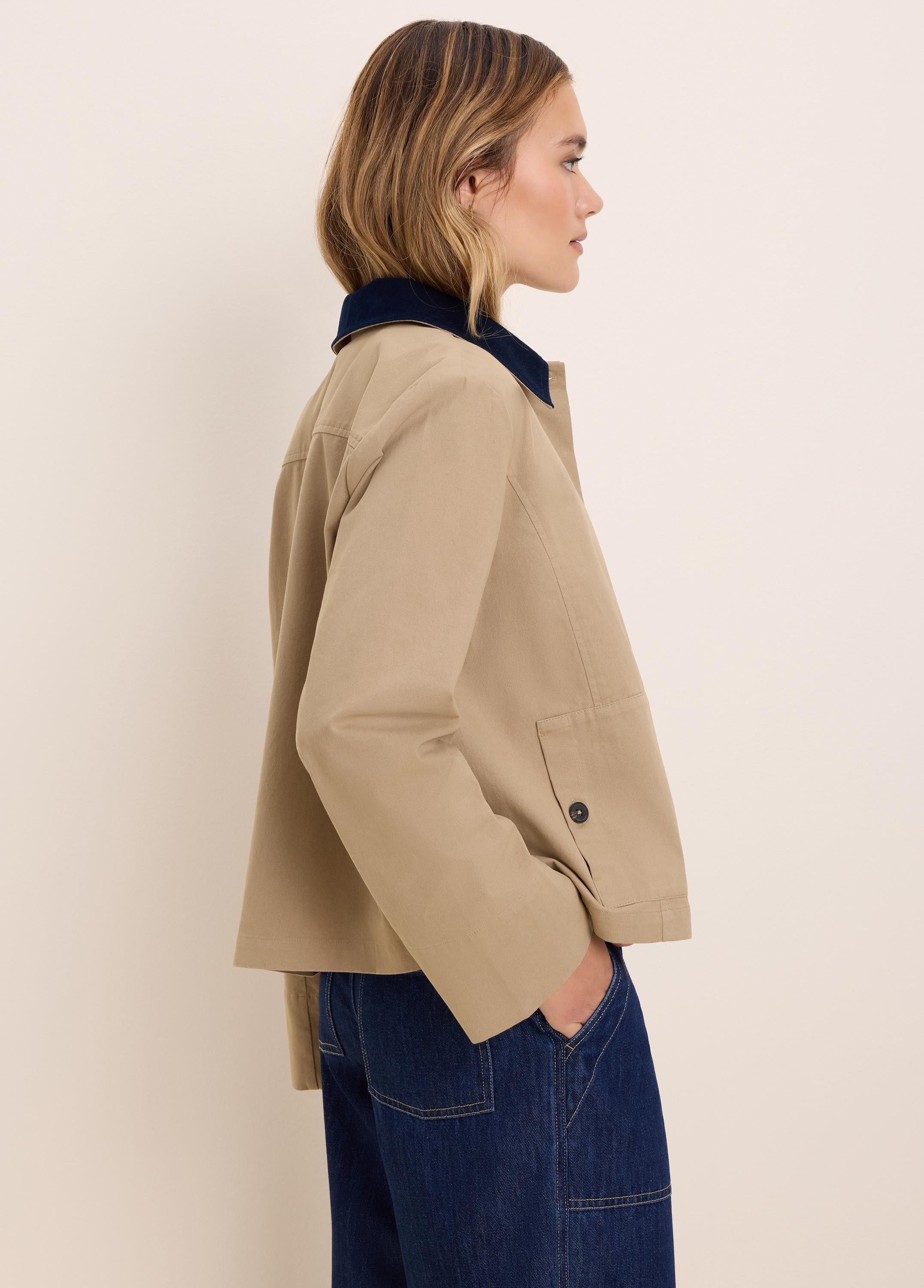 Tan twill jacket with a navy corduroy collar. Casual cut, features a buttoned patch pocket.