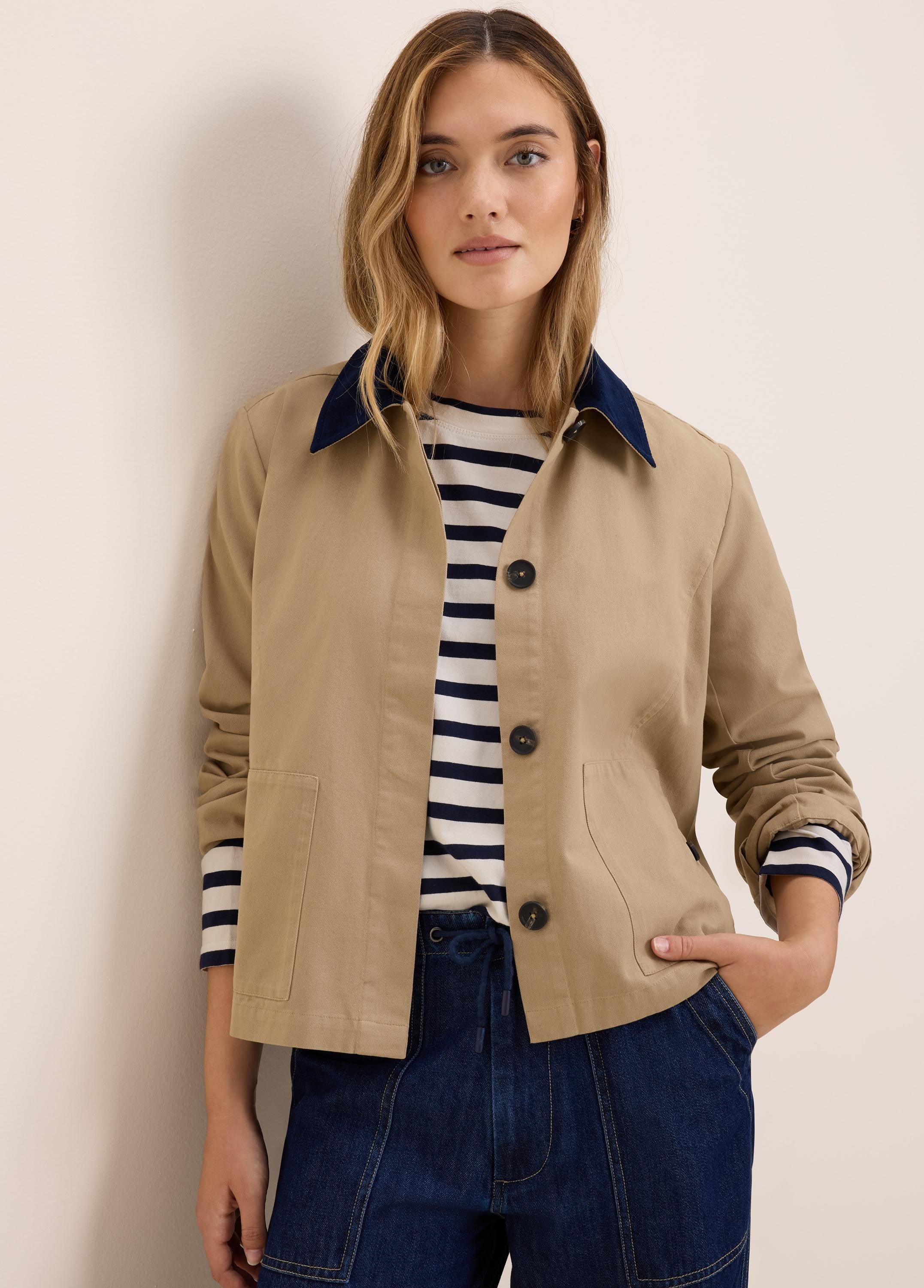 Tan twill jacket with dark blue cord collar, button front, and patch pockets.