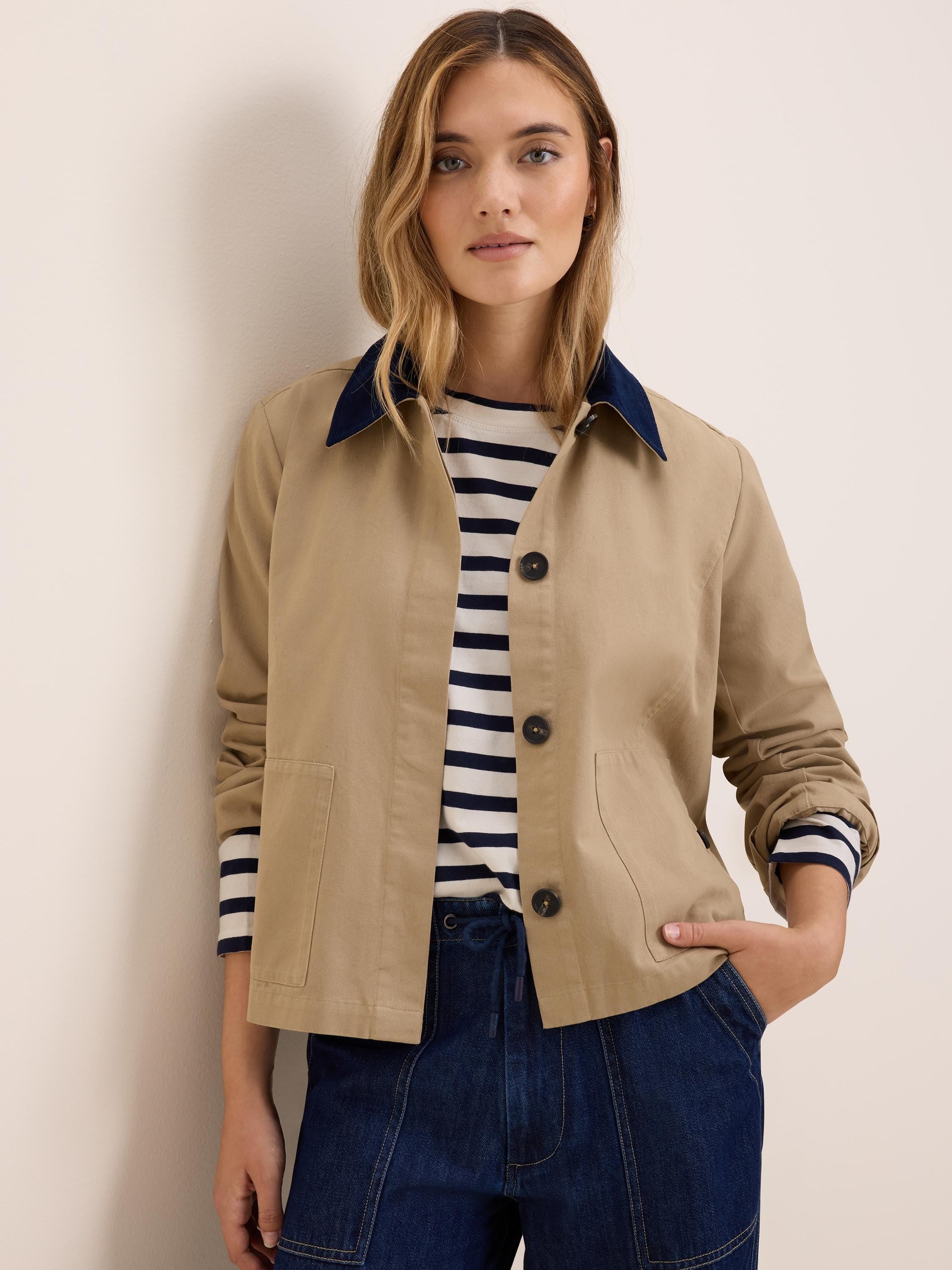 Tan twill jacket with dark blue cord collar, button front, and patch pockets.