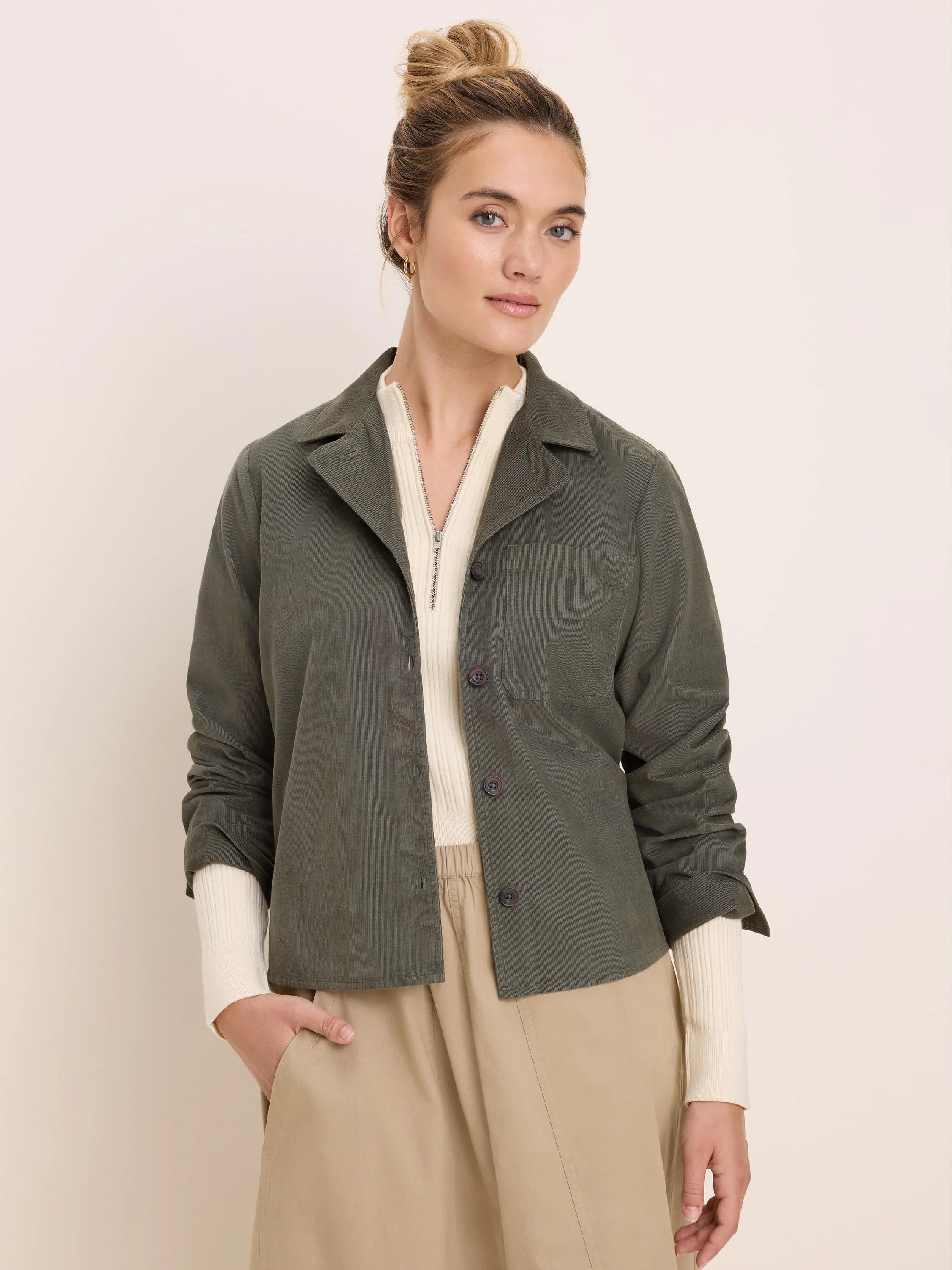 Dark olive green baby cord shirt jacket with a collar, button front, and single chest pocket.