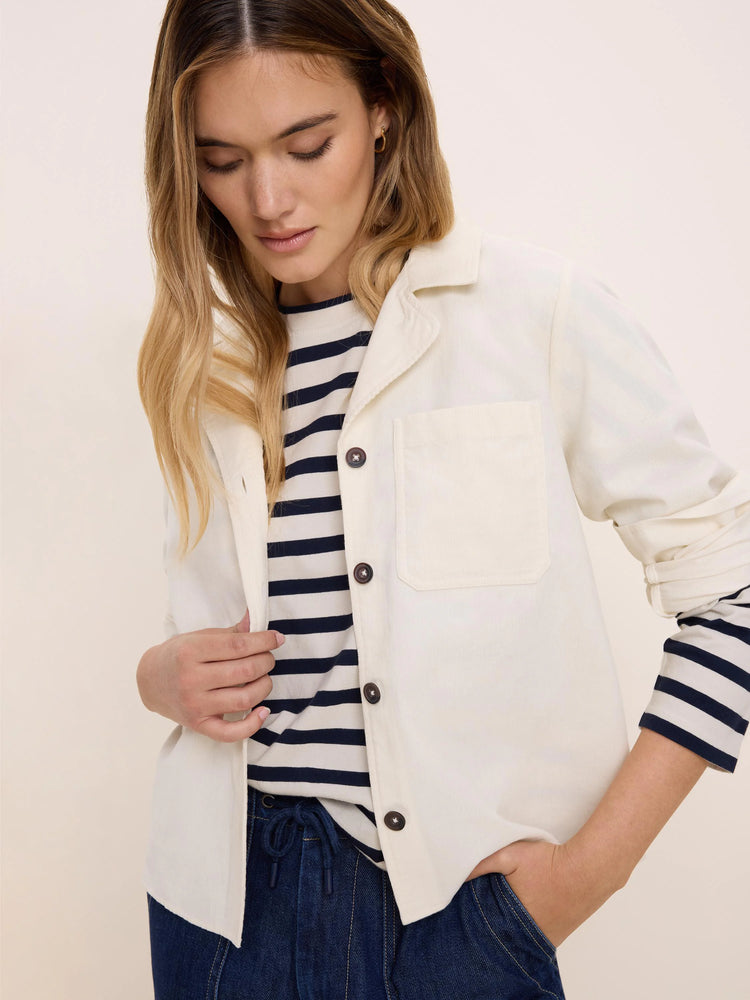 Cream baby cord shirt jacket with a collar, single chest pocket, and dark buttons.