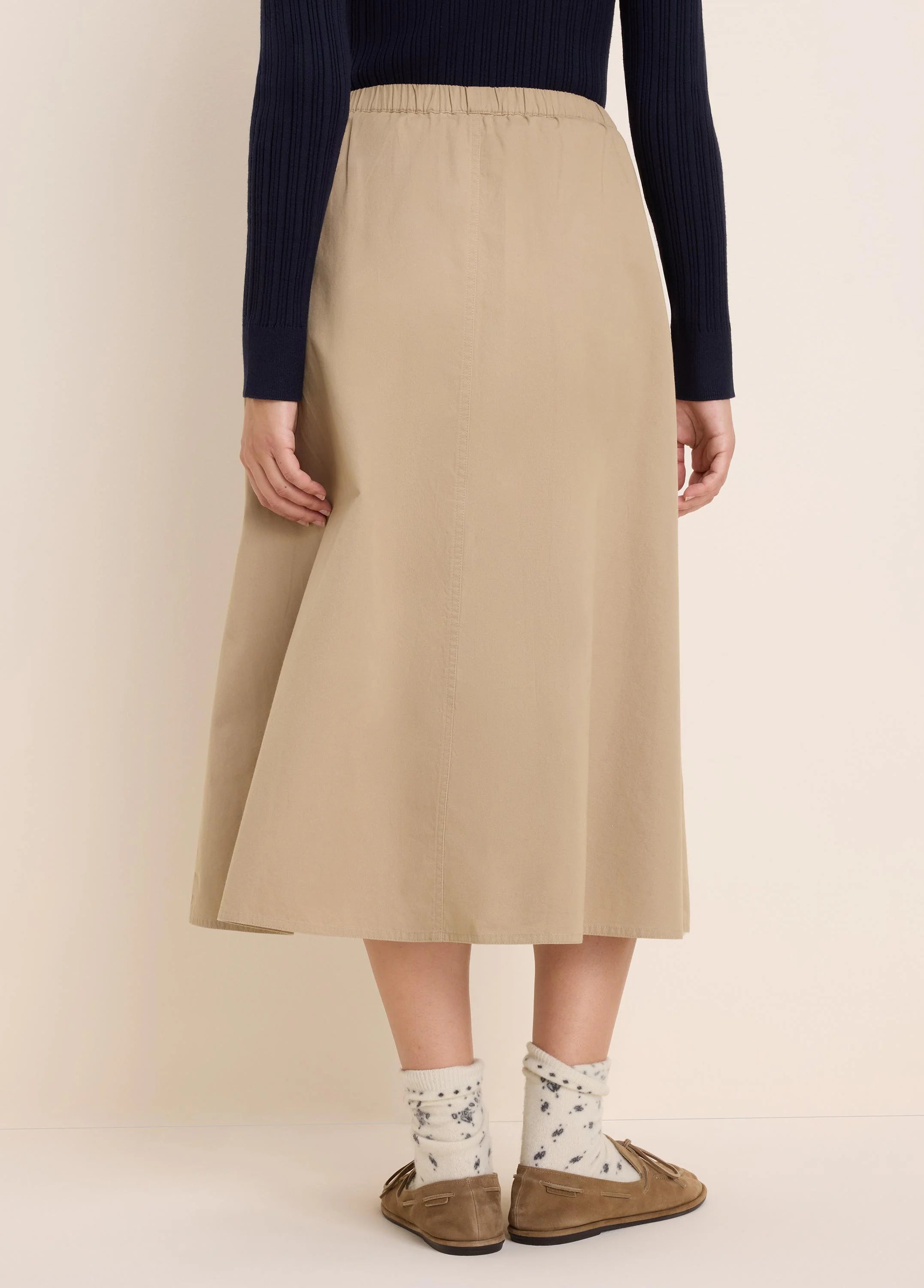 Khaki twill midi skirt with an elasticated waist. Features an A-line silhouette and subtle vertical seams.