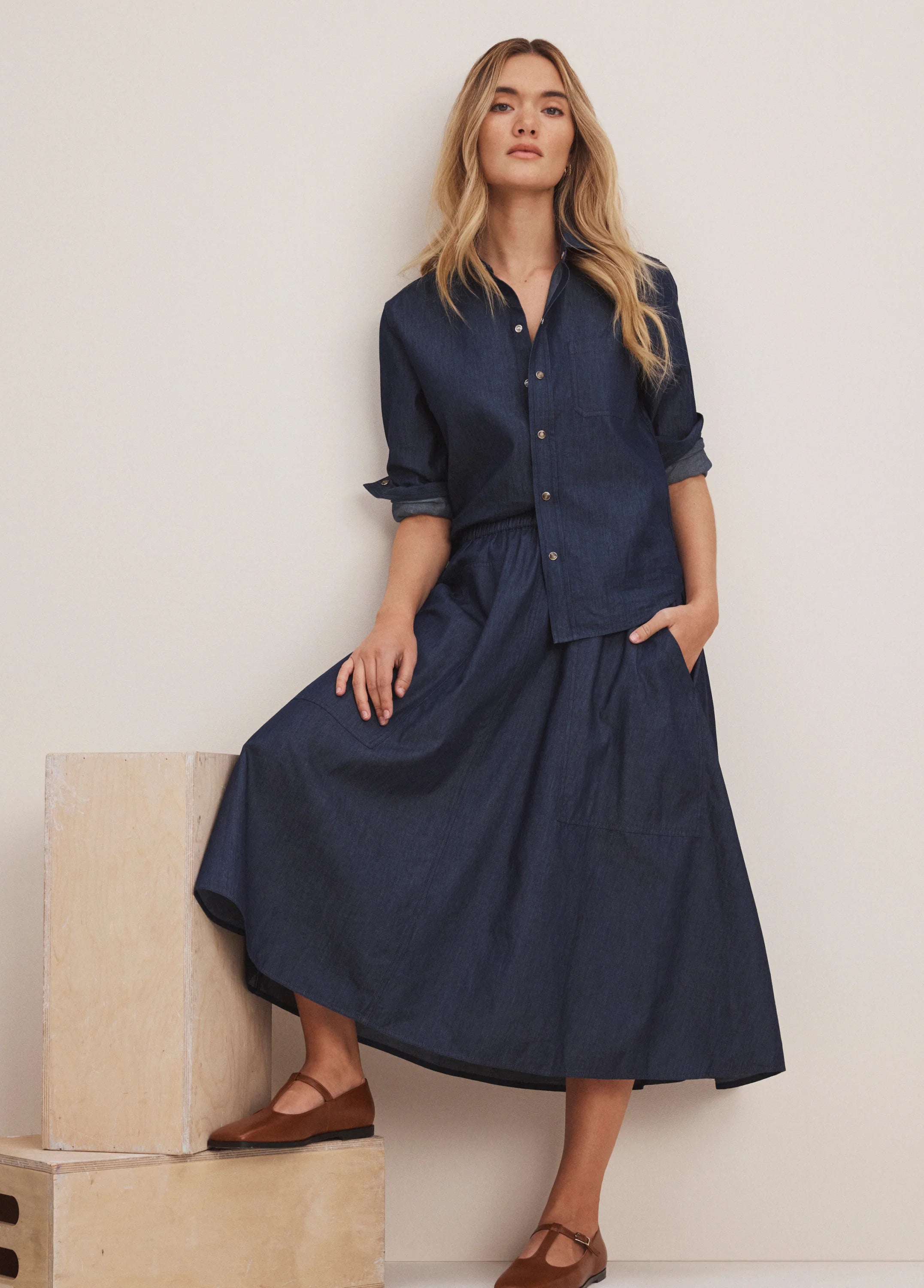 Drapey indigo denim midi cargo skirt with elastic waist & large patch pockets.