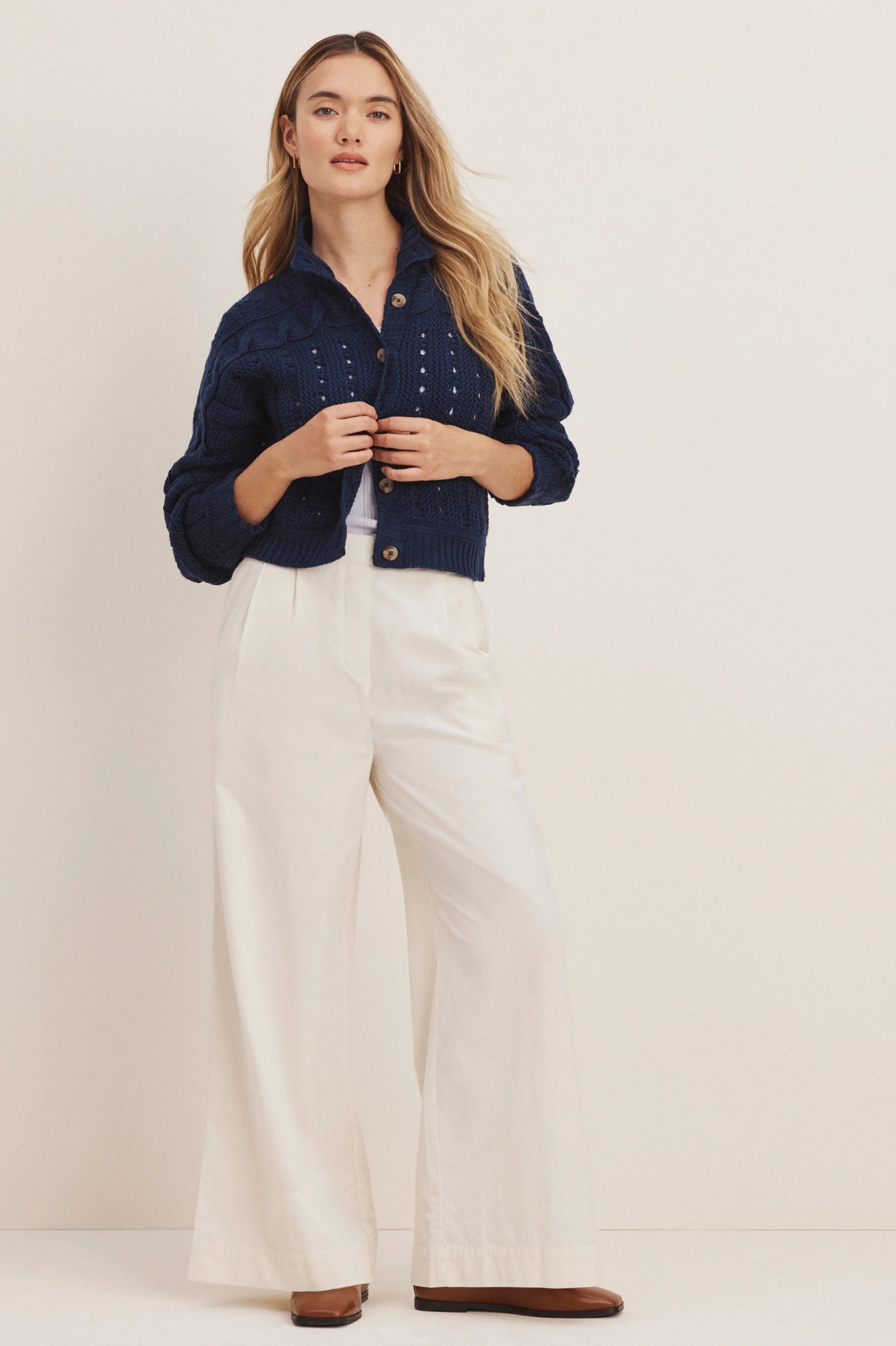 Off-white wide-leg baby cord pants, full-length on a standing model.