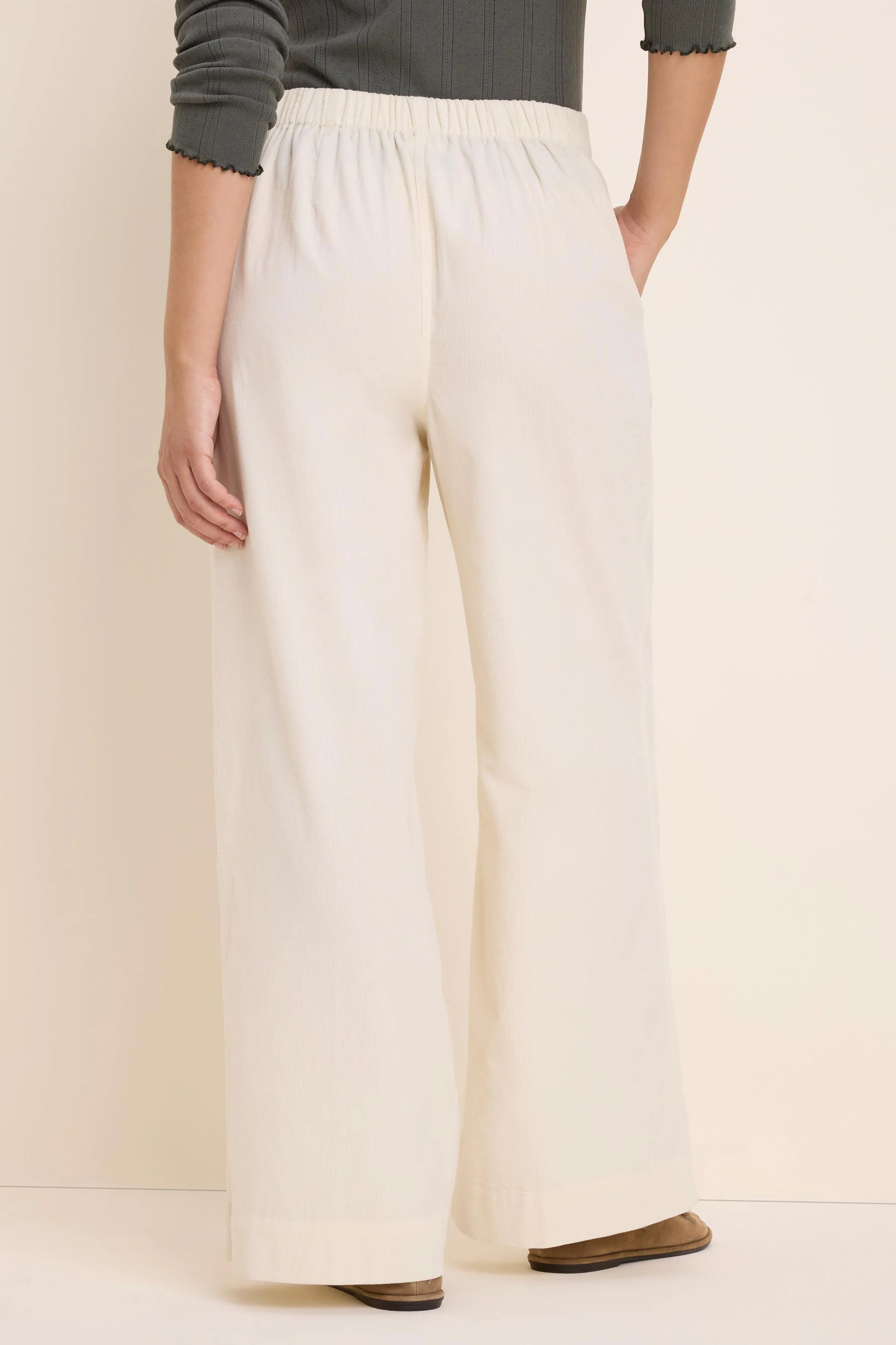 Off-white baby corduroy wide-leg pants with an elastic waist, shown from the back.