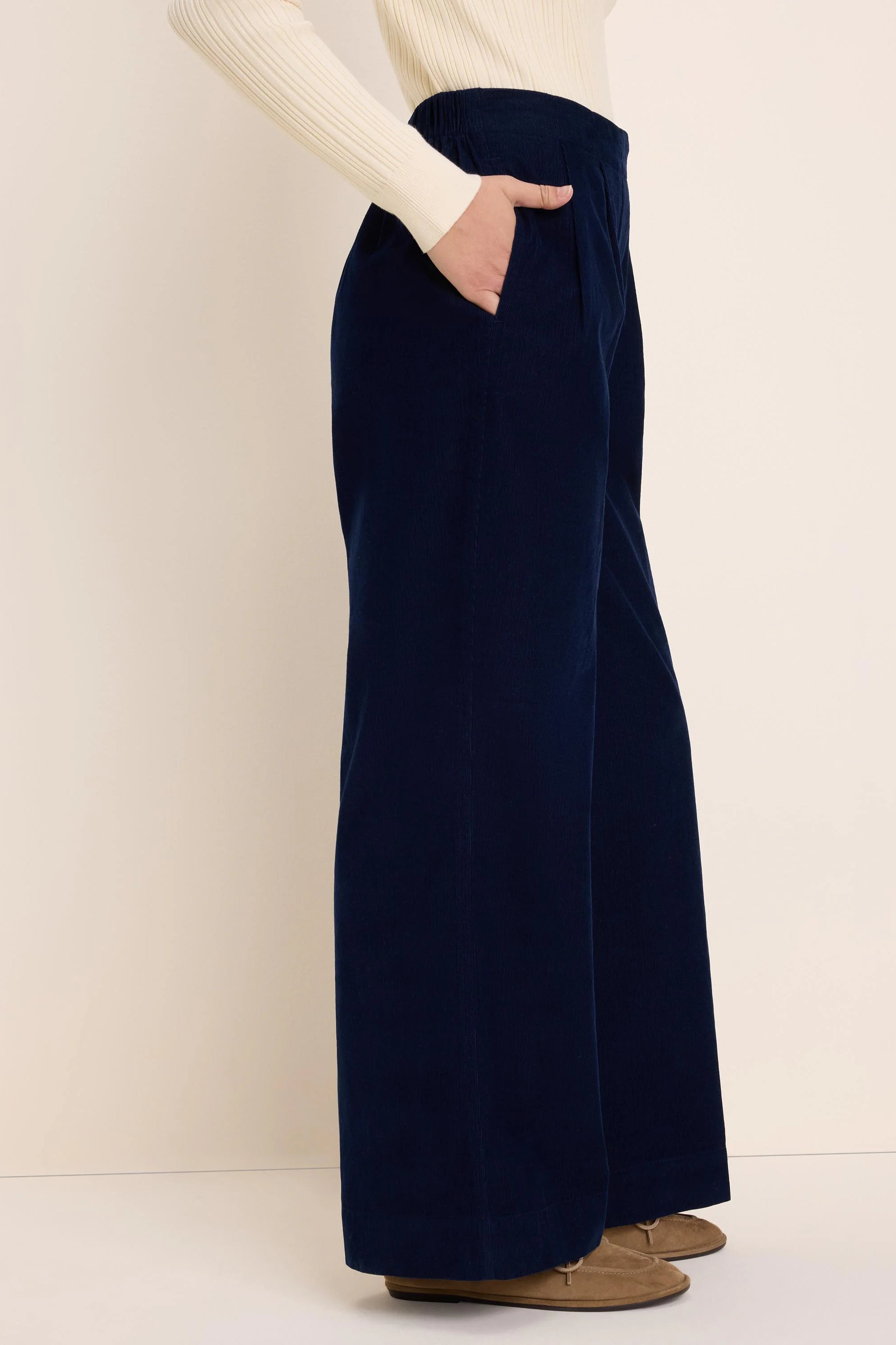 Navy baby corduroy wide-leg pants with a gathered waist and a side pocket, worn by a model.
