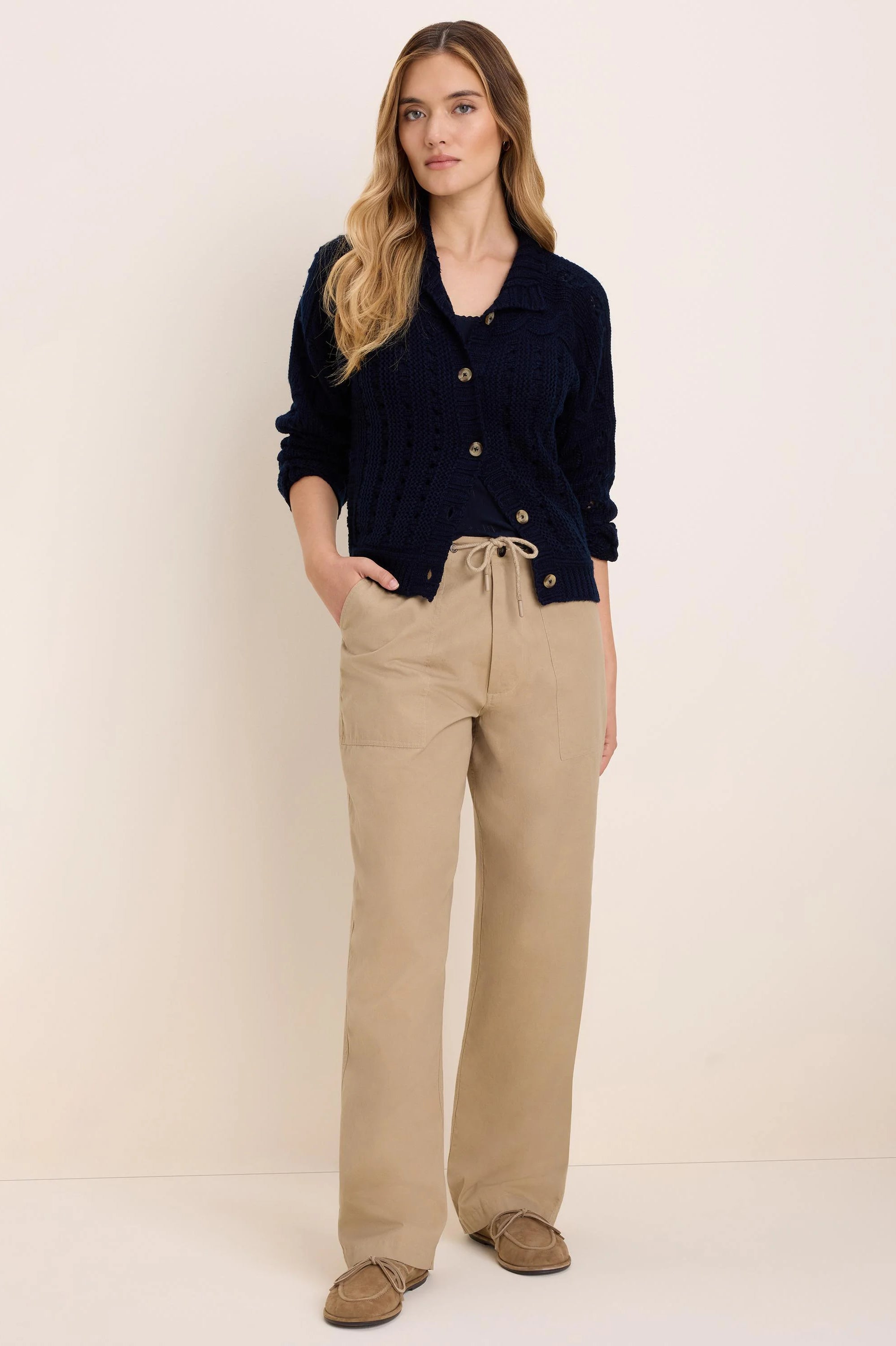 Khaki drawstring twill pants with a tied waist, front patch pockets, and a relaxed, wide-leg fit.