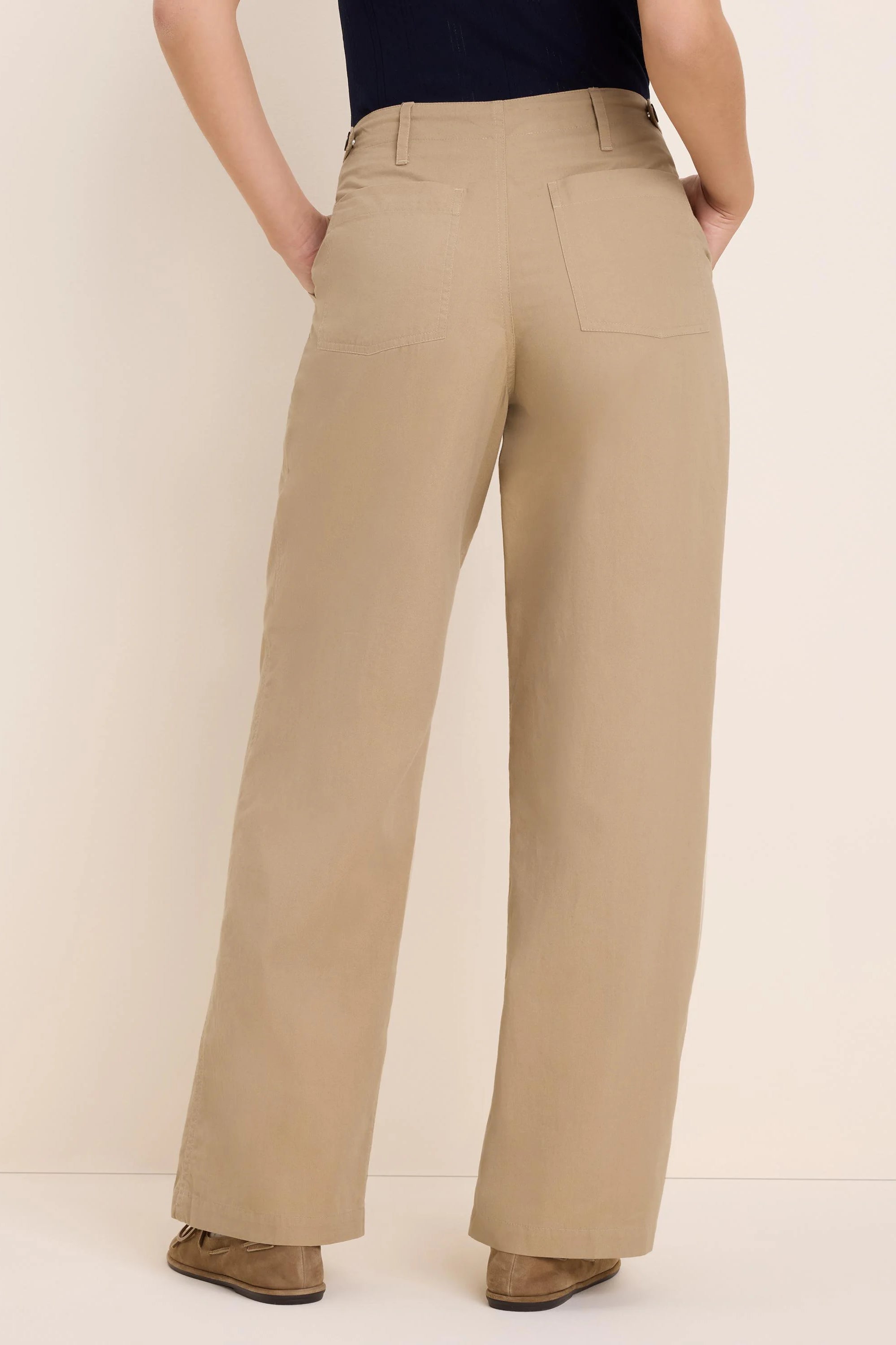 Khaki wide-leg twill pants from the back, showing belt loops and two large rear patch pockets.
