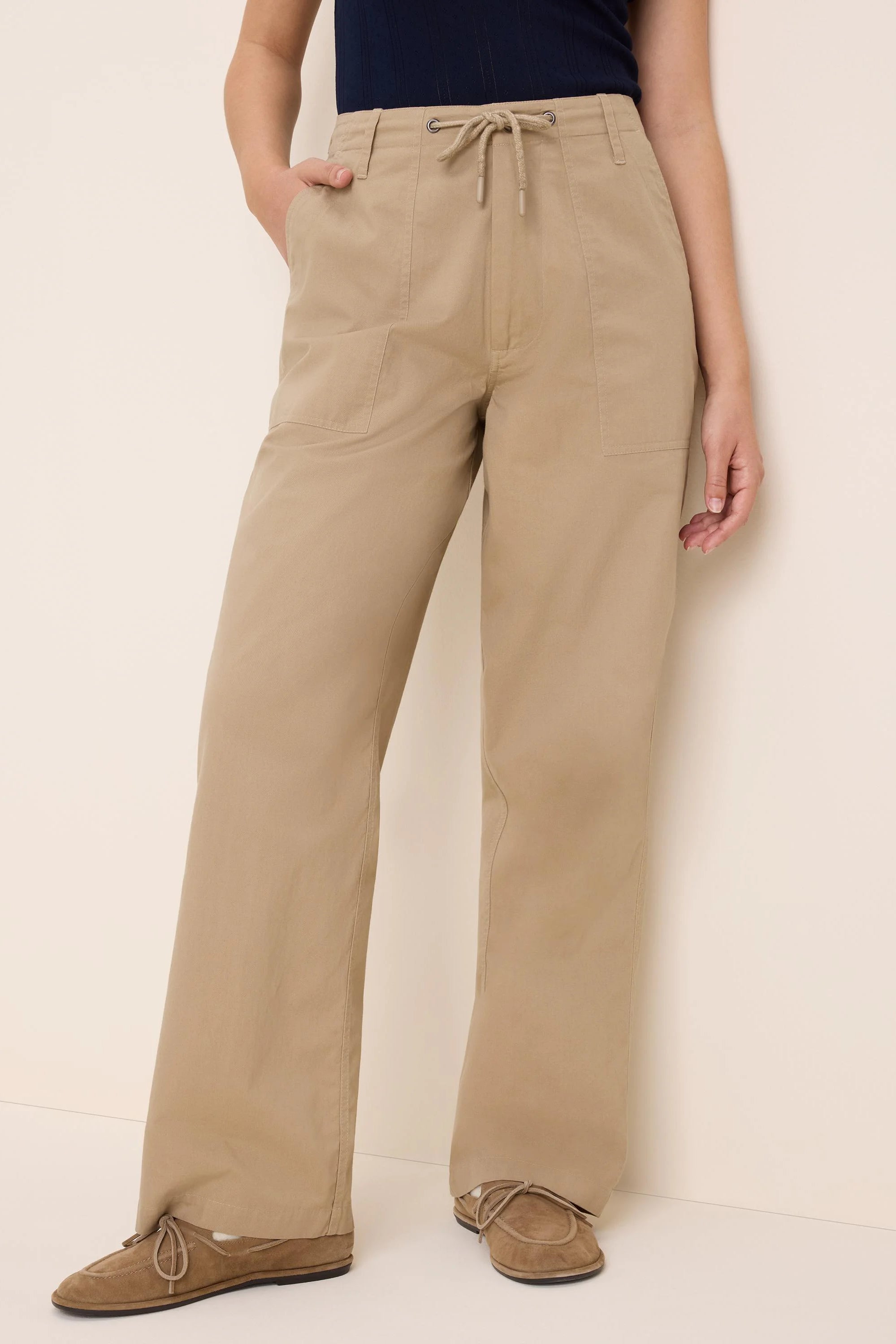 Khaki twill pants with drawstring waist, wide legs, and large front pockets.
