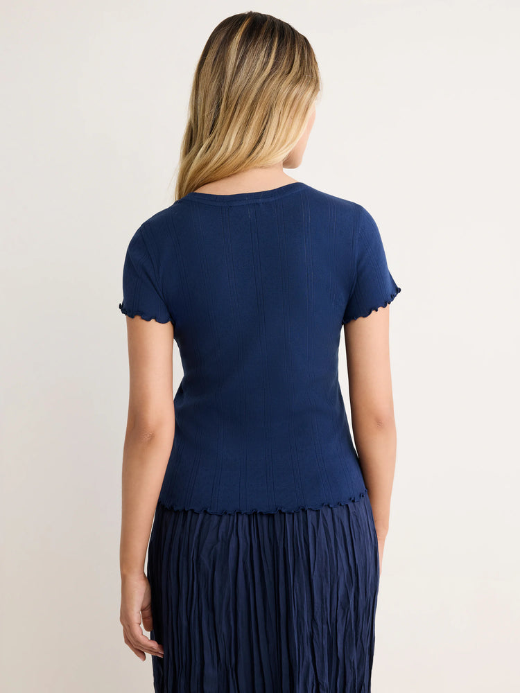 Navy blue pointelle rib tee with short sleeves and scalloped trim on sleeves and hem.
