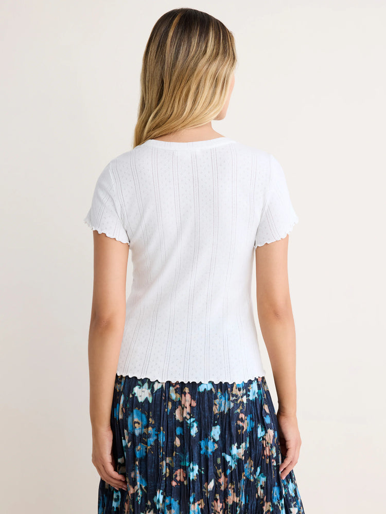 White pointelle rib short-sleeve tee with scalloped trim on sleeves and hem.