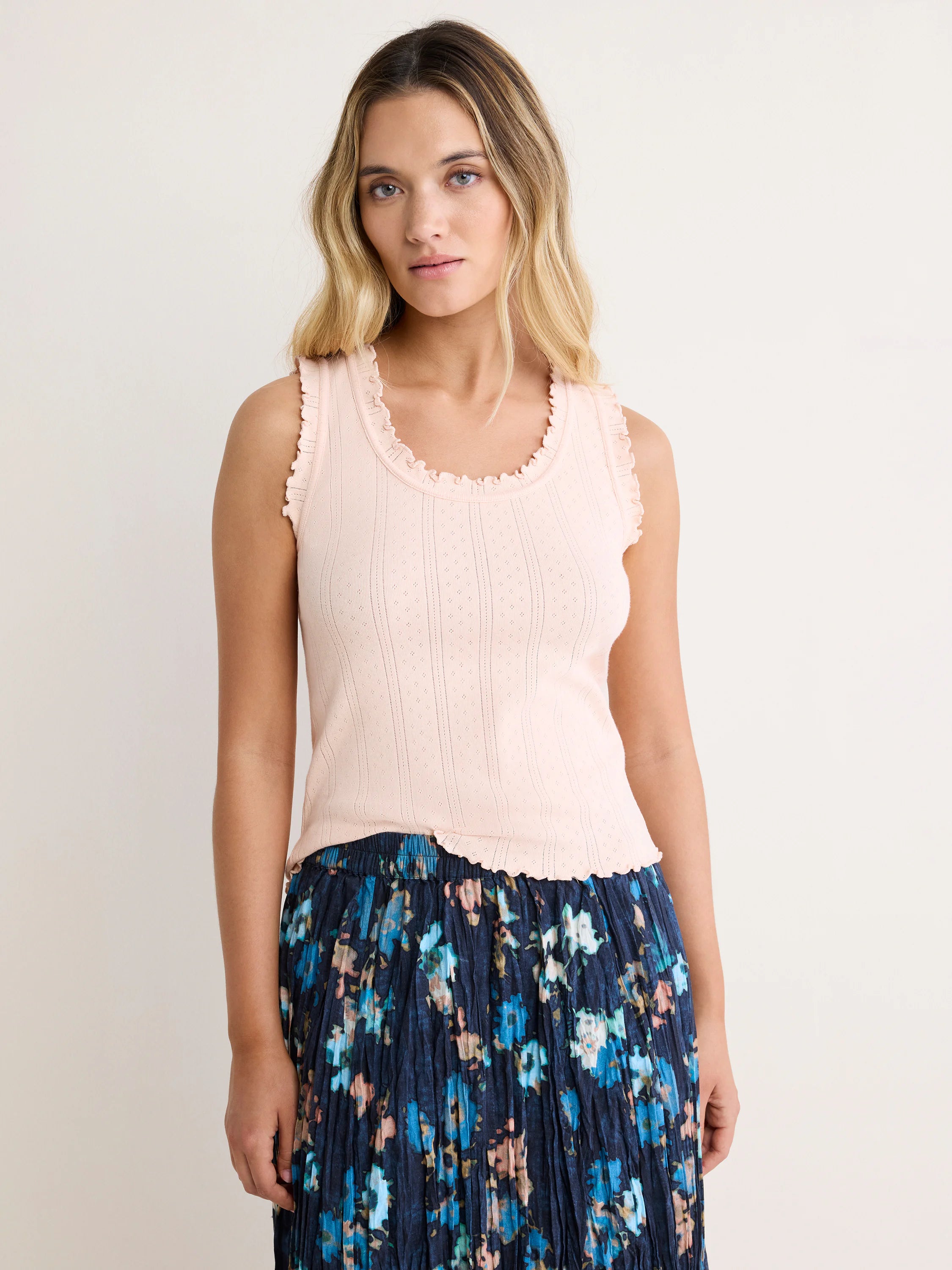 Light pink pointelle rib tank with scalloped trim on neckline, armholes, and hem.