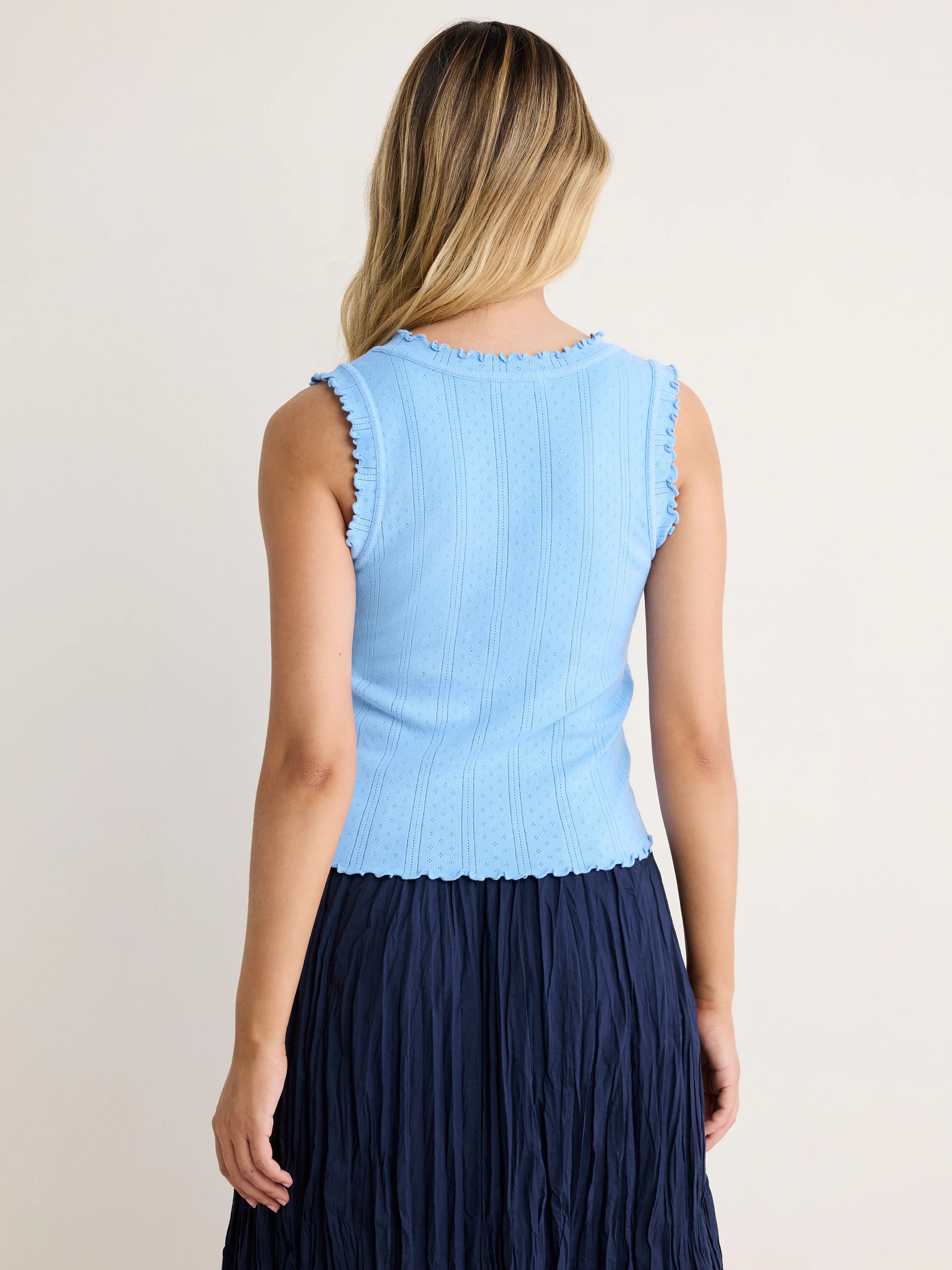 Light blue pointelle rib tank top with scalloped neckline, armholes, and hem.
