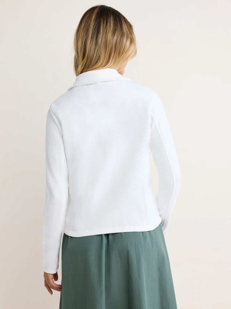 White long-sleeved jacket with a relaxed fit, featuring raw edge collar and cuffs. Back view on model.