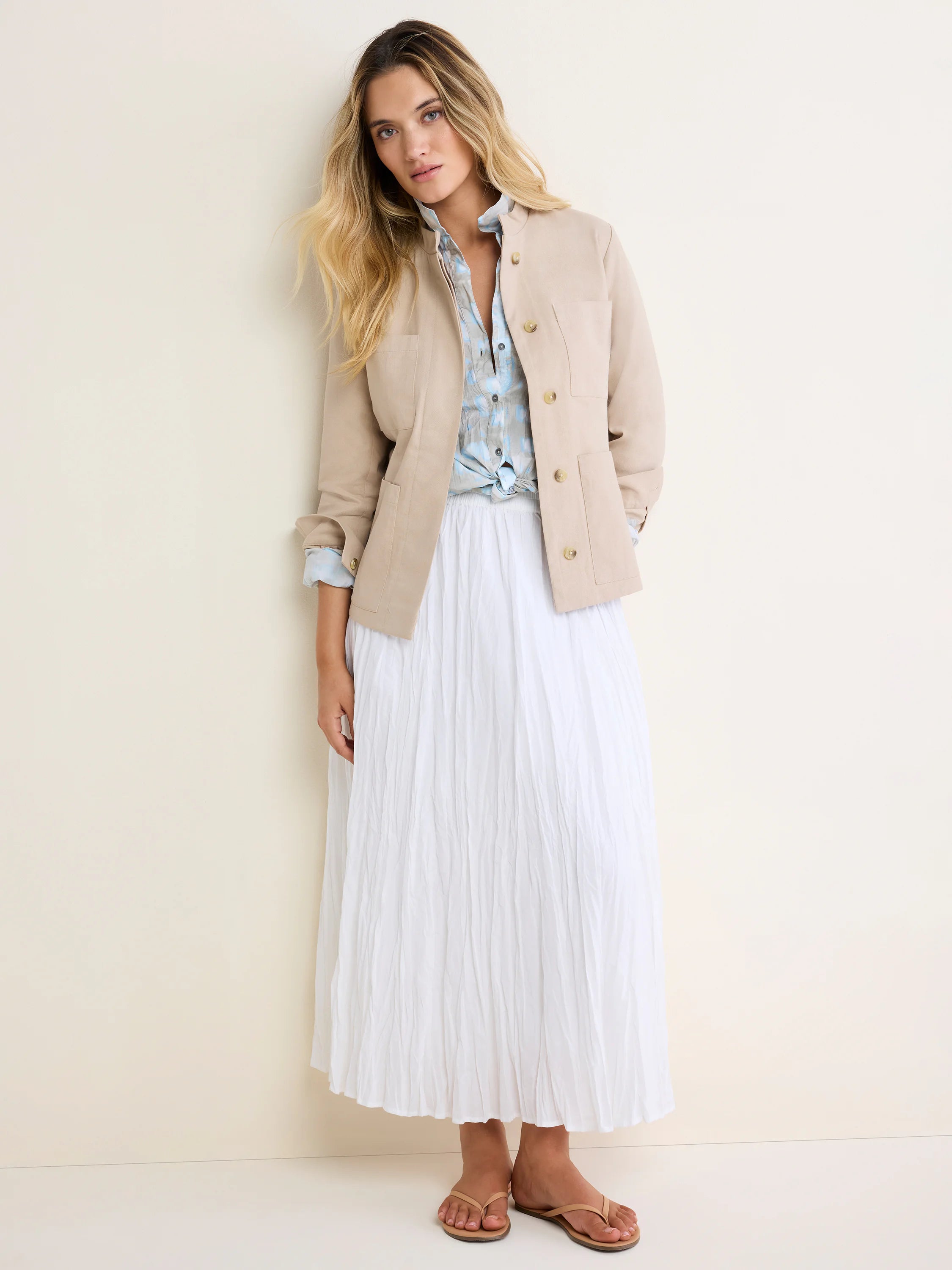 Light beige barn jacket with a stand collar, button front, and four patch pockets.