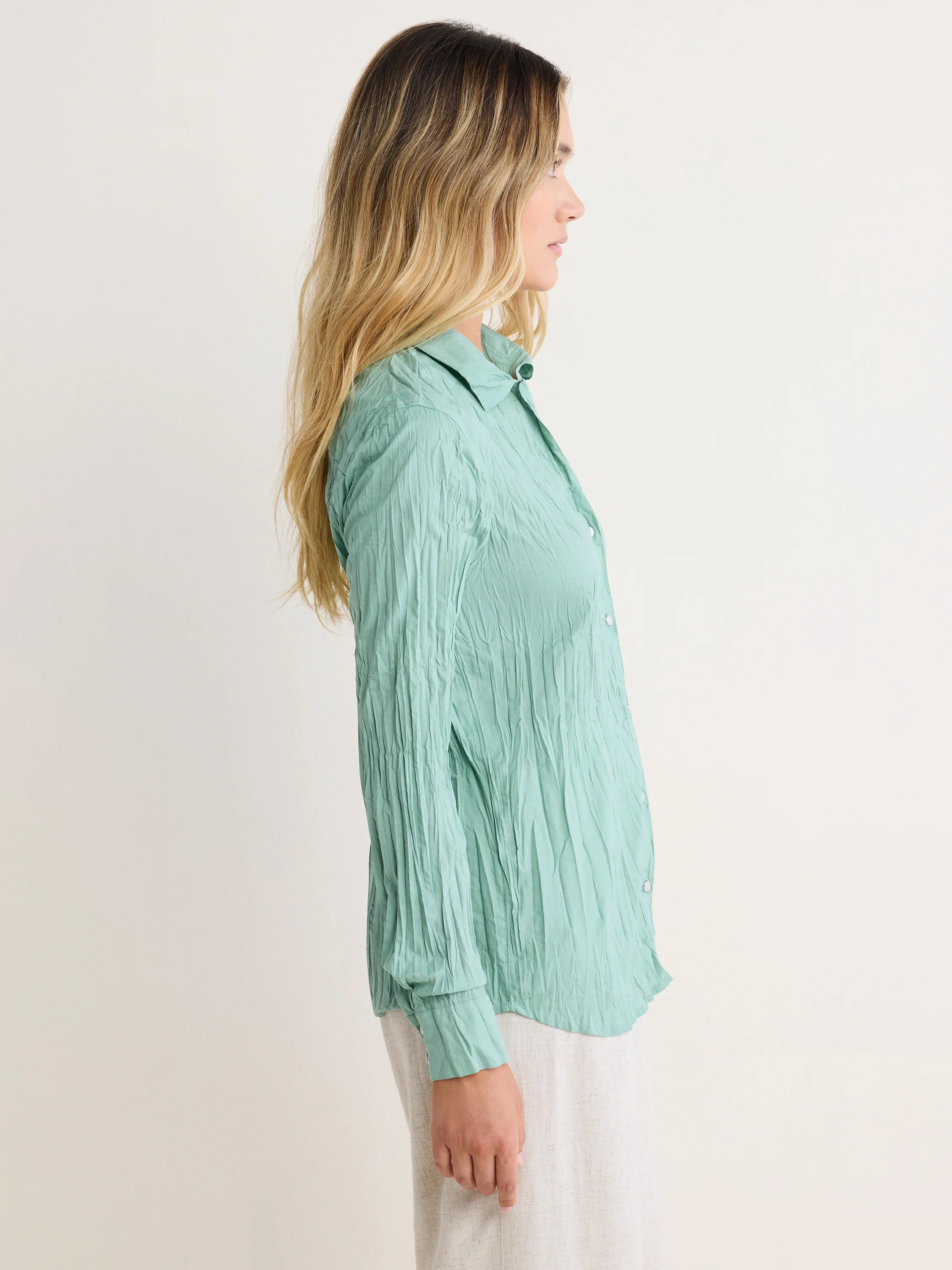 Mint green long-sleeved crinkled cotton shirt.