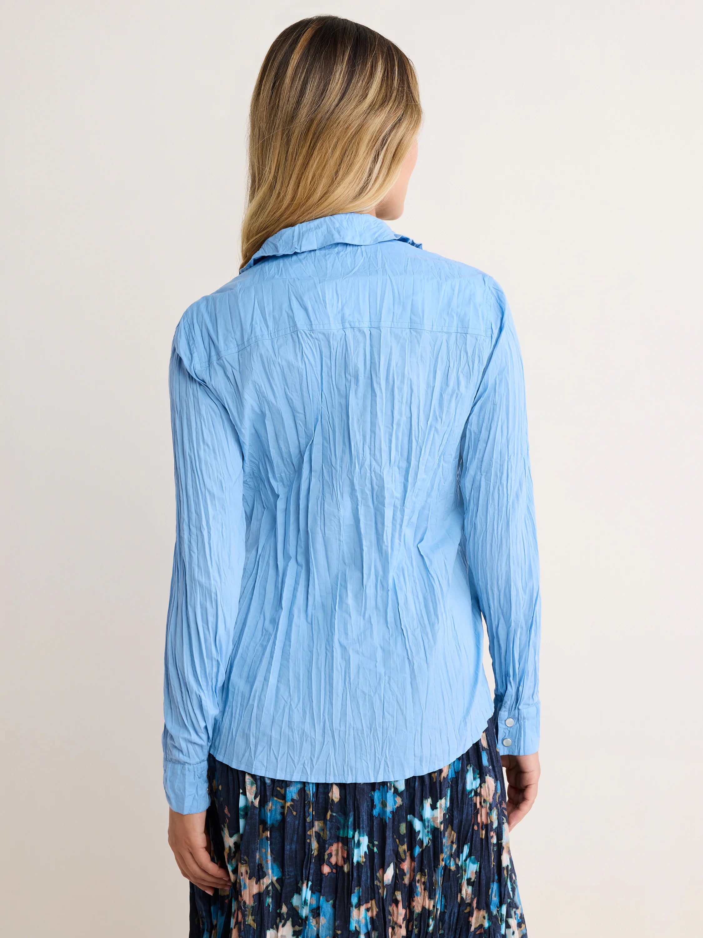 Light blue long-sleeve shirt with a prominent crinkled texture, shown from the back.