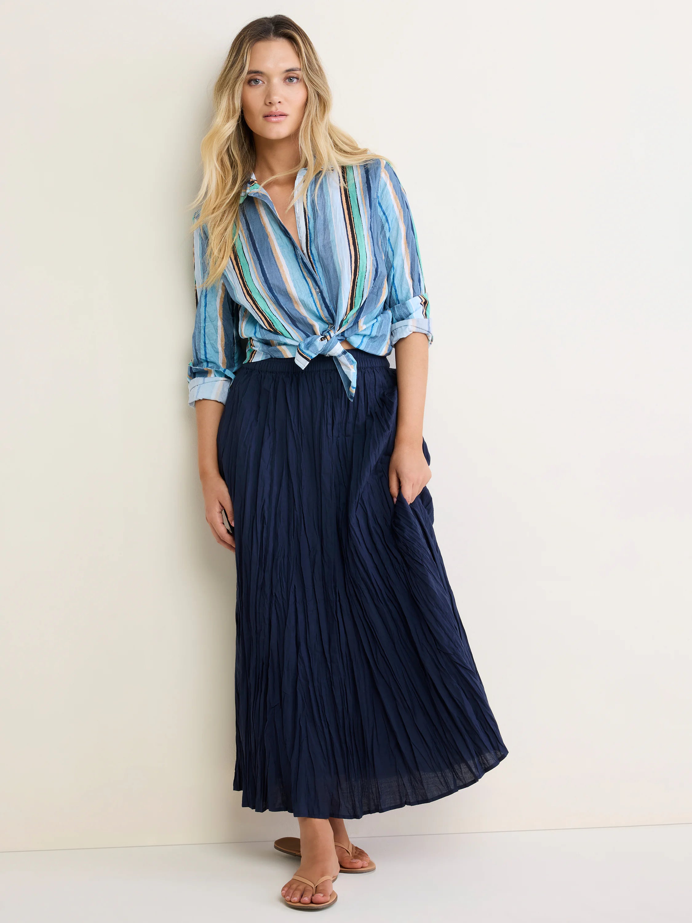 Vertical multi-color striped cotton shirt in shades of blue, green, tan, and black, tied at waist.