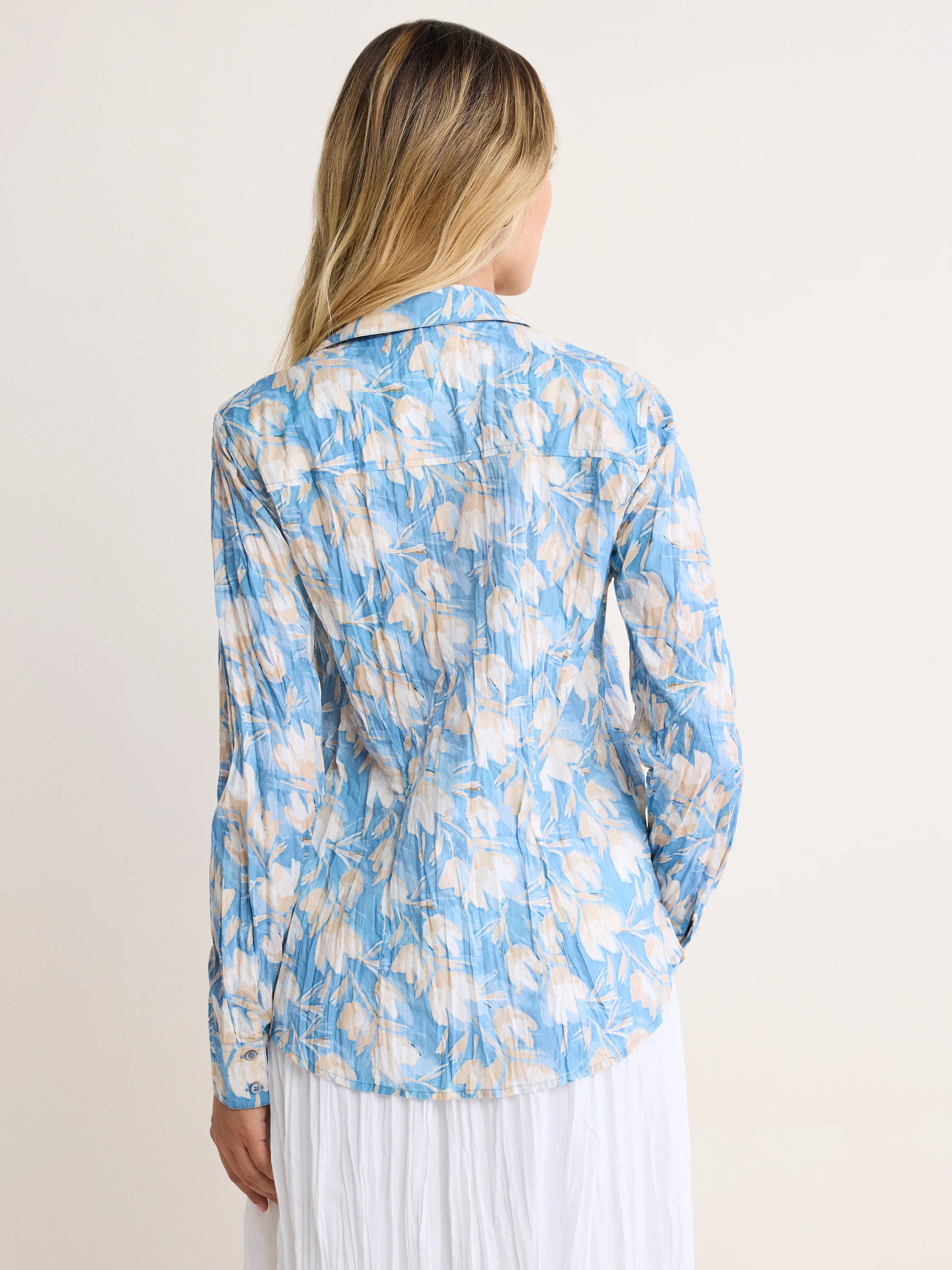 Crinkled light blue shirt with subtle beige 'shadow floral' pattern, shown on a model from behind.