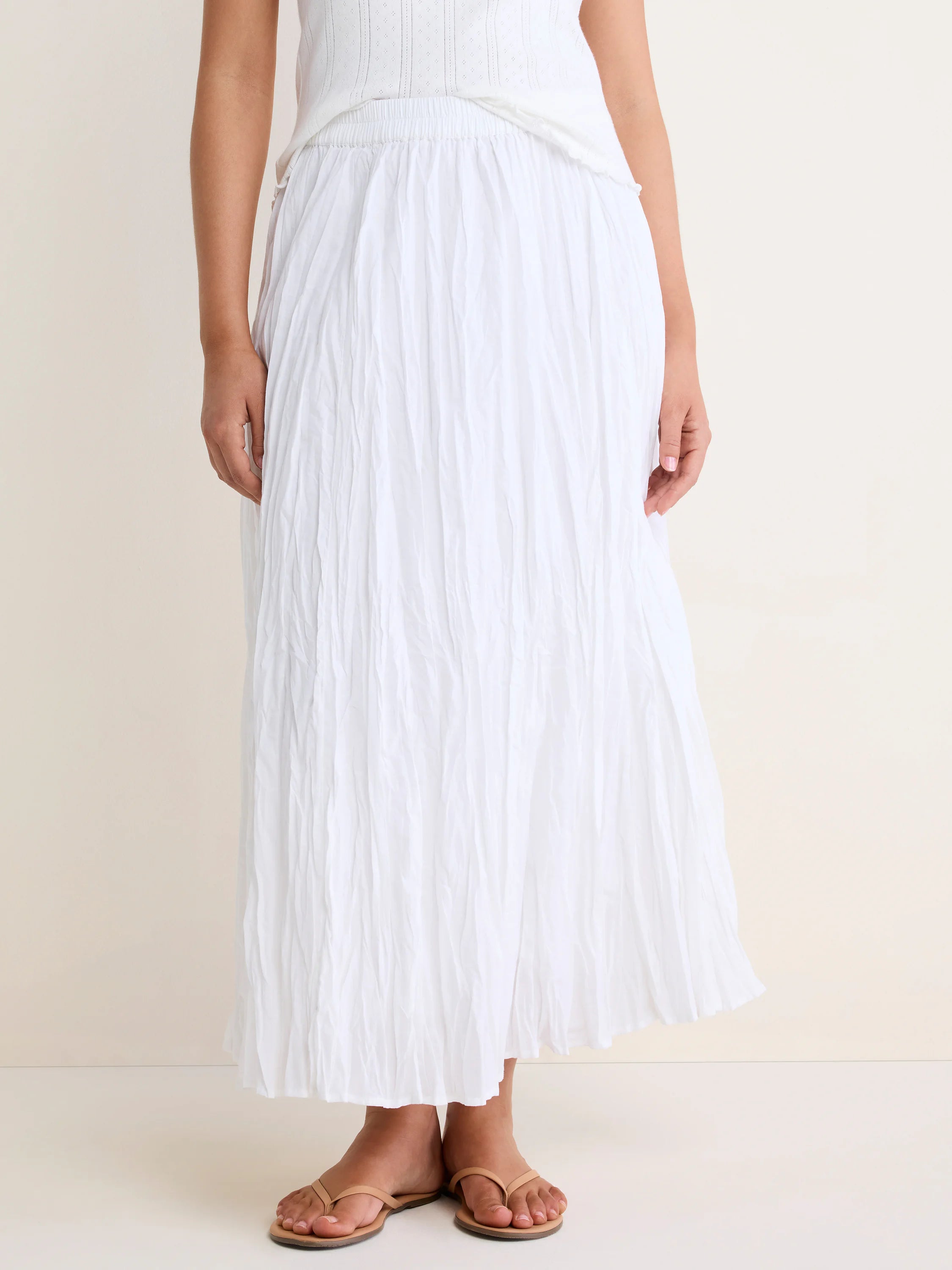White, flowy crinkled skirt with an elastic waist, shown ankle-length on a model.