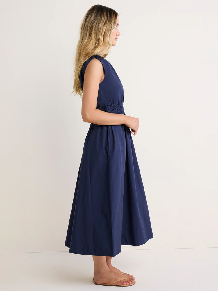 Navy blue sleeveless poplin dress with a cinched waist and flared midi skirt.
