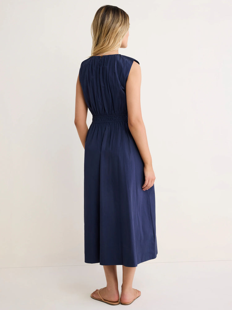 Navy sleeveless midi dress with gathered top and elasticated waist, viewed from the back.