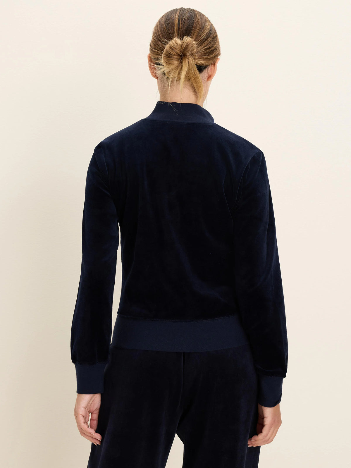 Navy velour half-zip pullover with ribbed cuffs and hem, worn by a woman from the back, with matching pants.