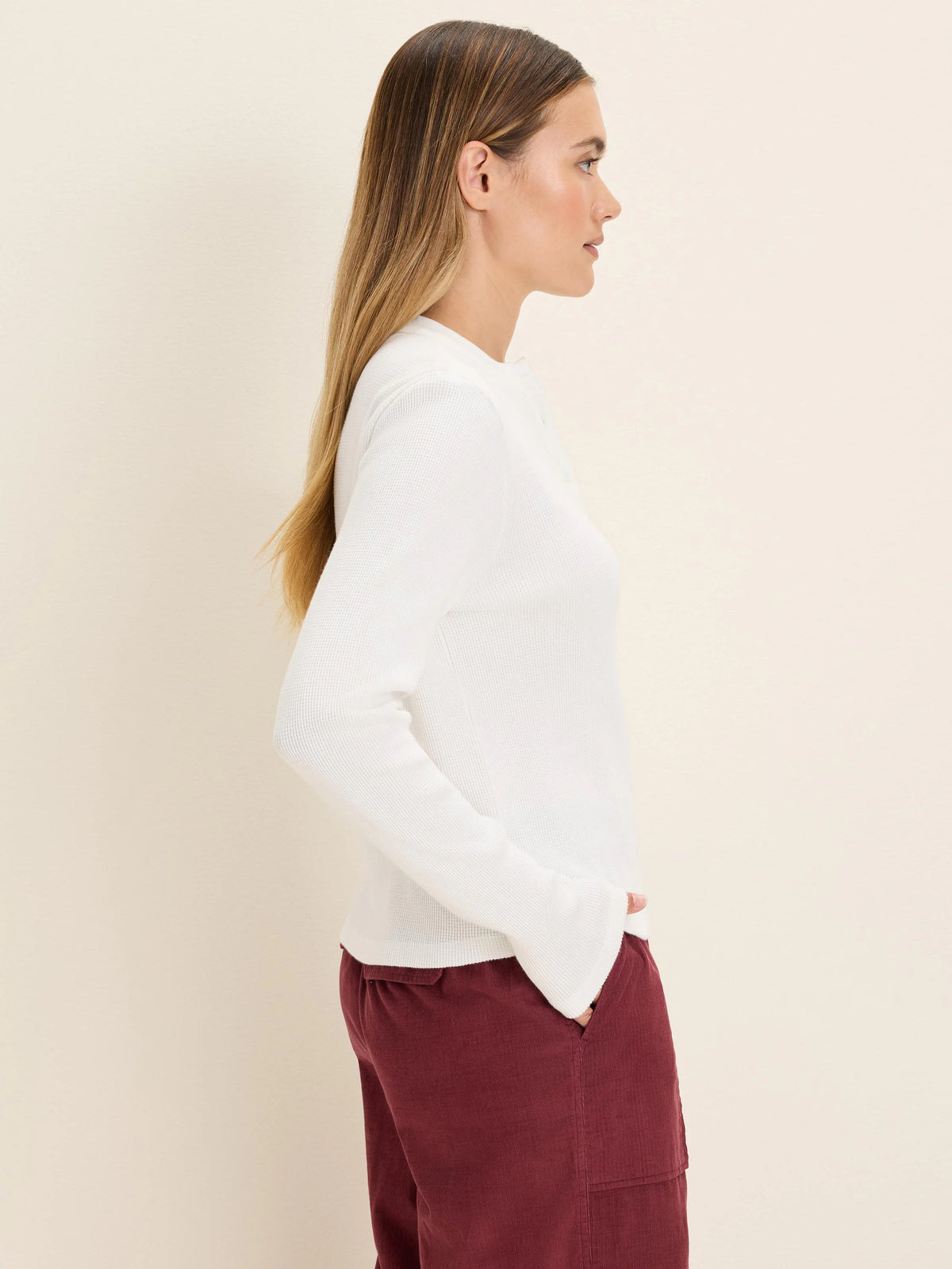 White long-sleeve thermal Henley top with a waffle knit texture.