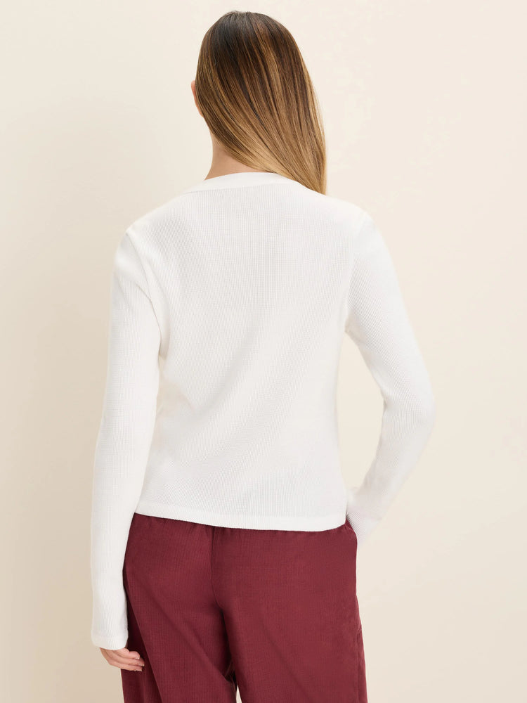 White thermal henley top with a waffle knit texture and long sleeves, shown from the back.