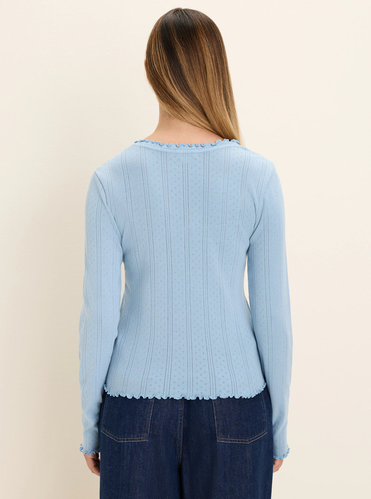 Light blue pointelle rib long sleeve tee with ruffled trim at the neckline, cuffs, and hem, shown from the back.