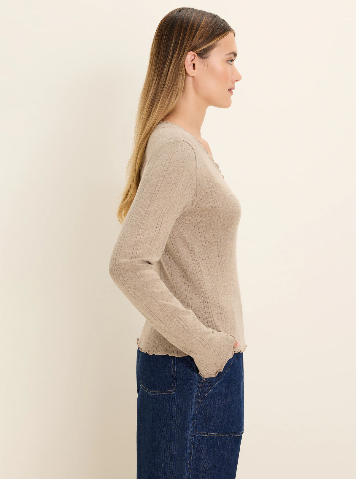 Beige tee with textured pointelle rib knit. Features vertical ribs, small openwork details, and scalloped edges.