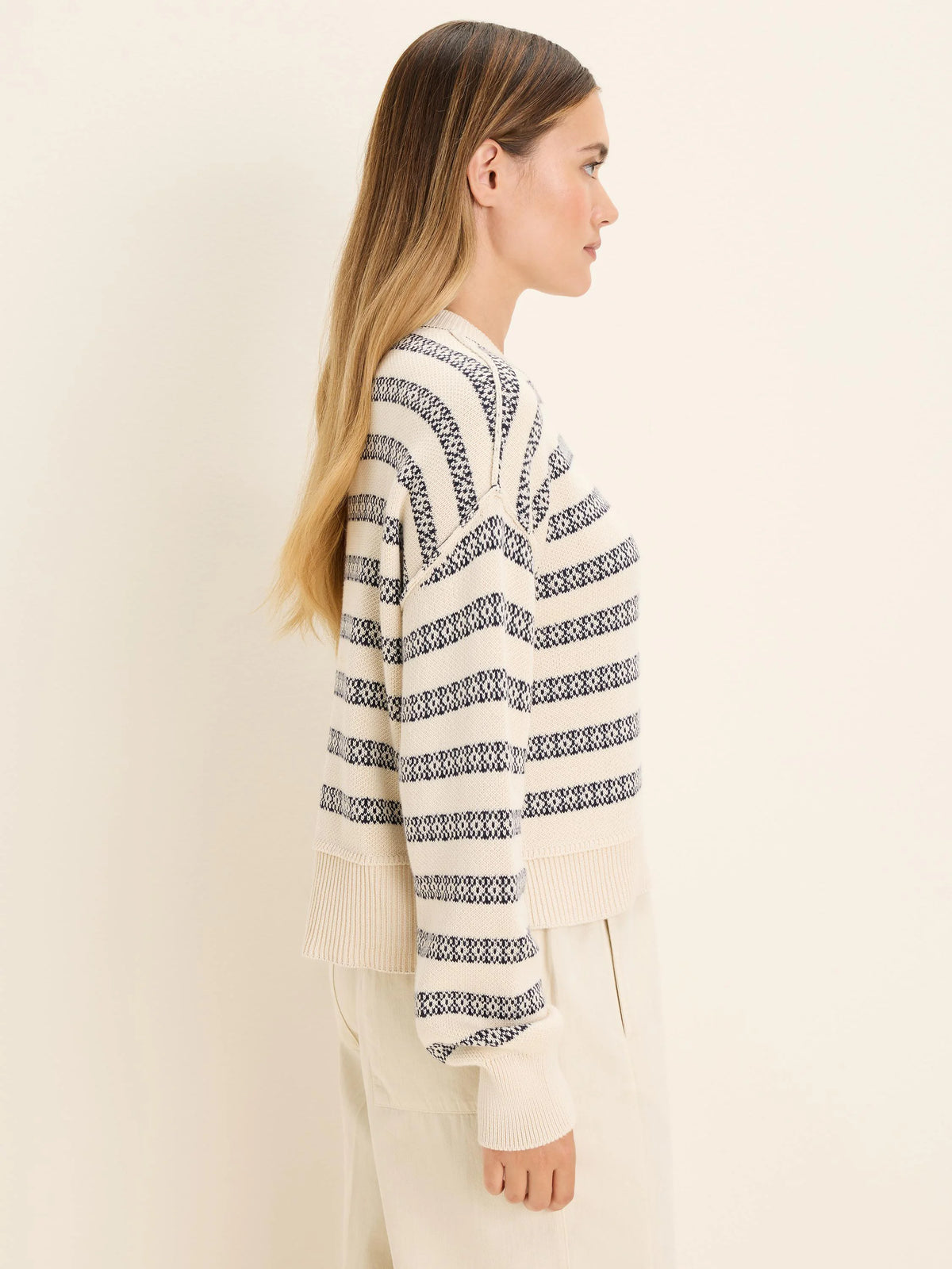Ecru cotton jacquard sweater with navy horizontal stripes and small woven patterns.