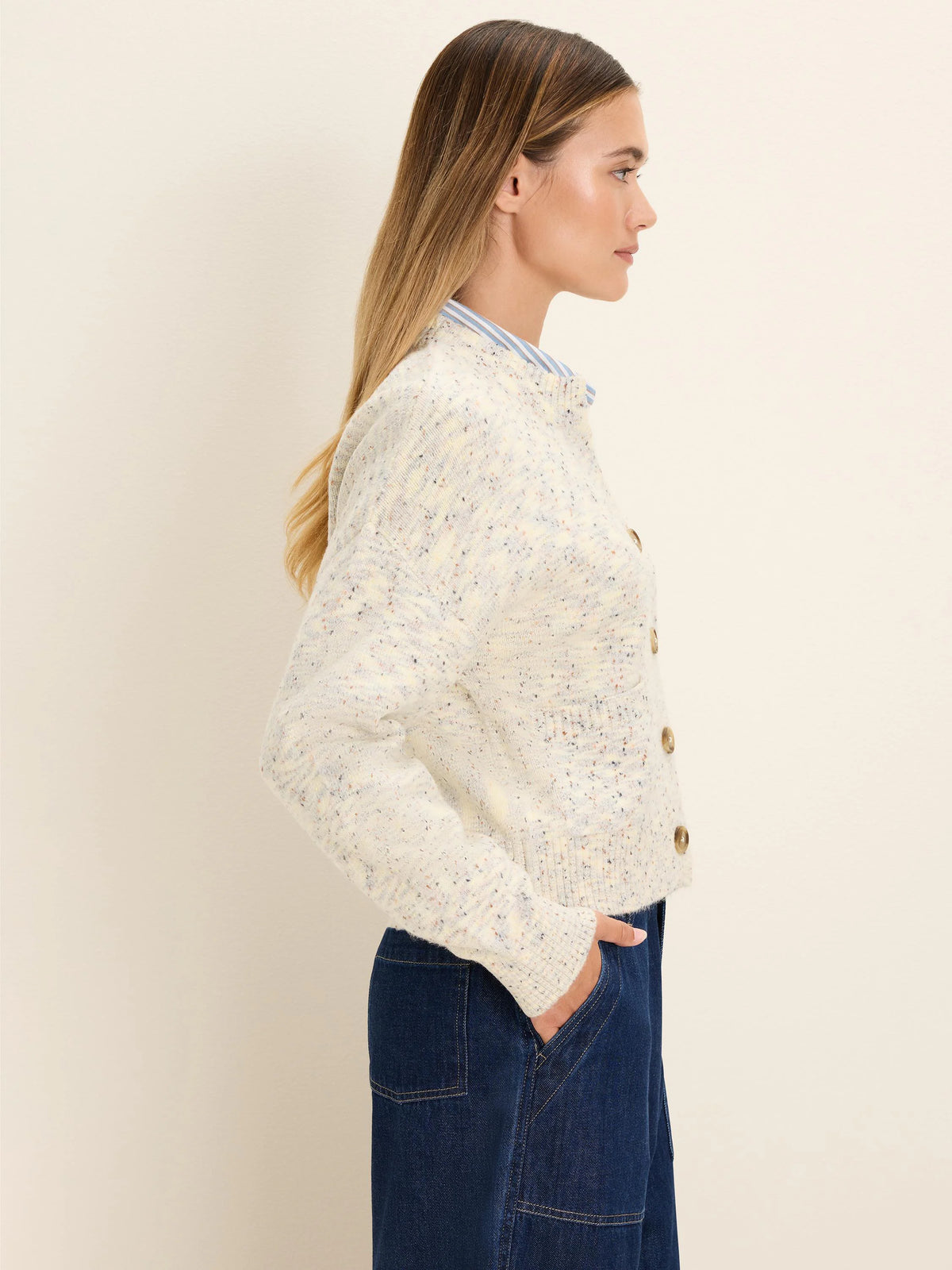 Slouchy cream flecked cardigan with round brown buttons. Cropped fit.