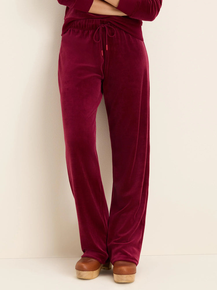 Burgundy velour pants with an elastic drawstring waist. Straight leg style.
